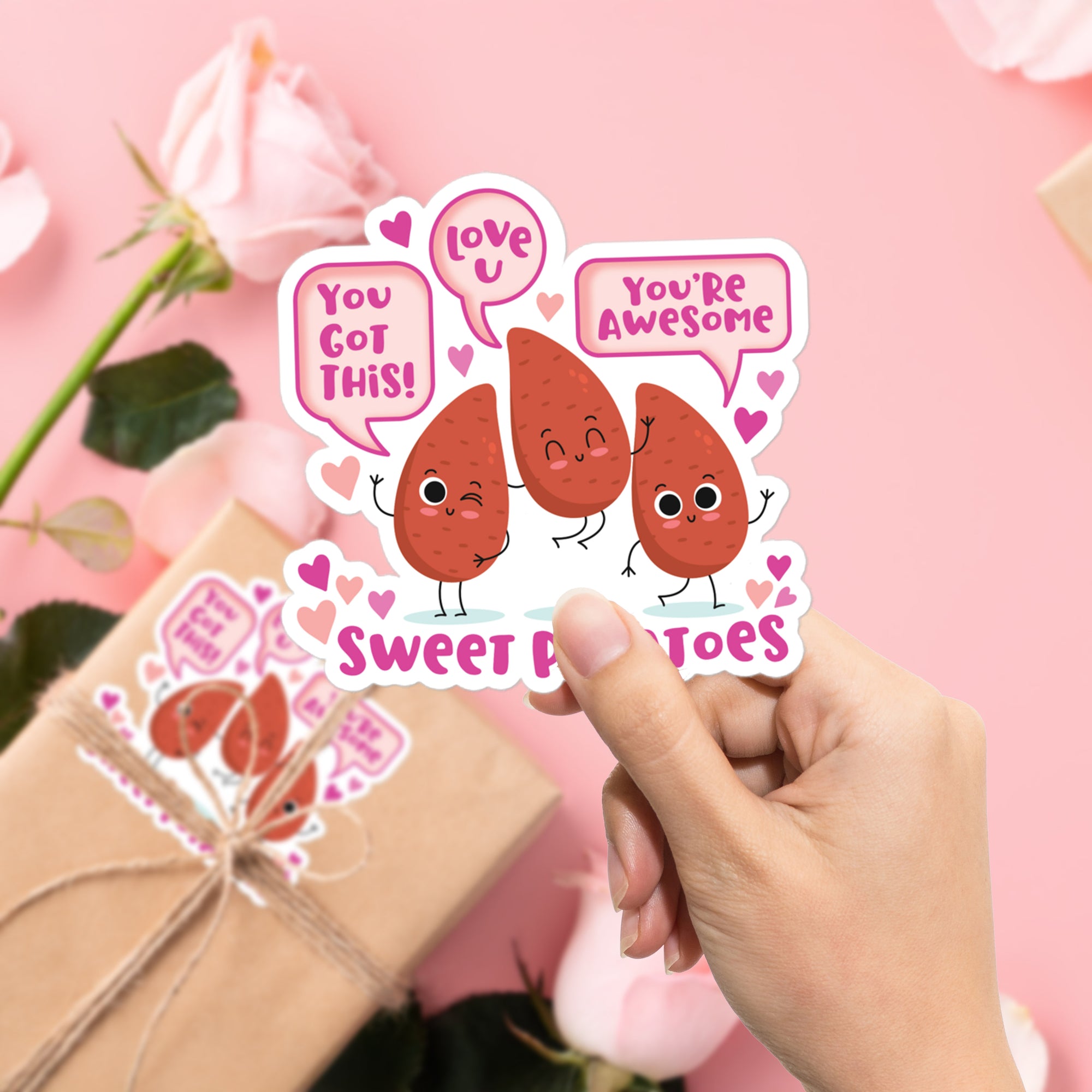 a person holding up a sticker with two hearts on it