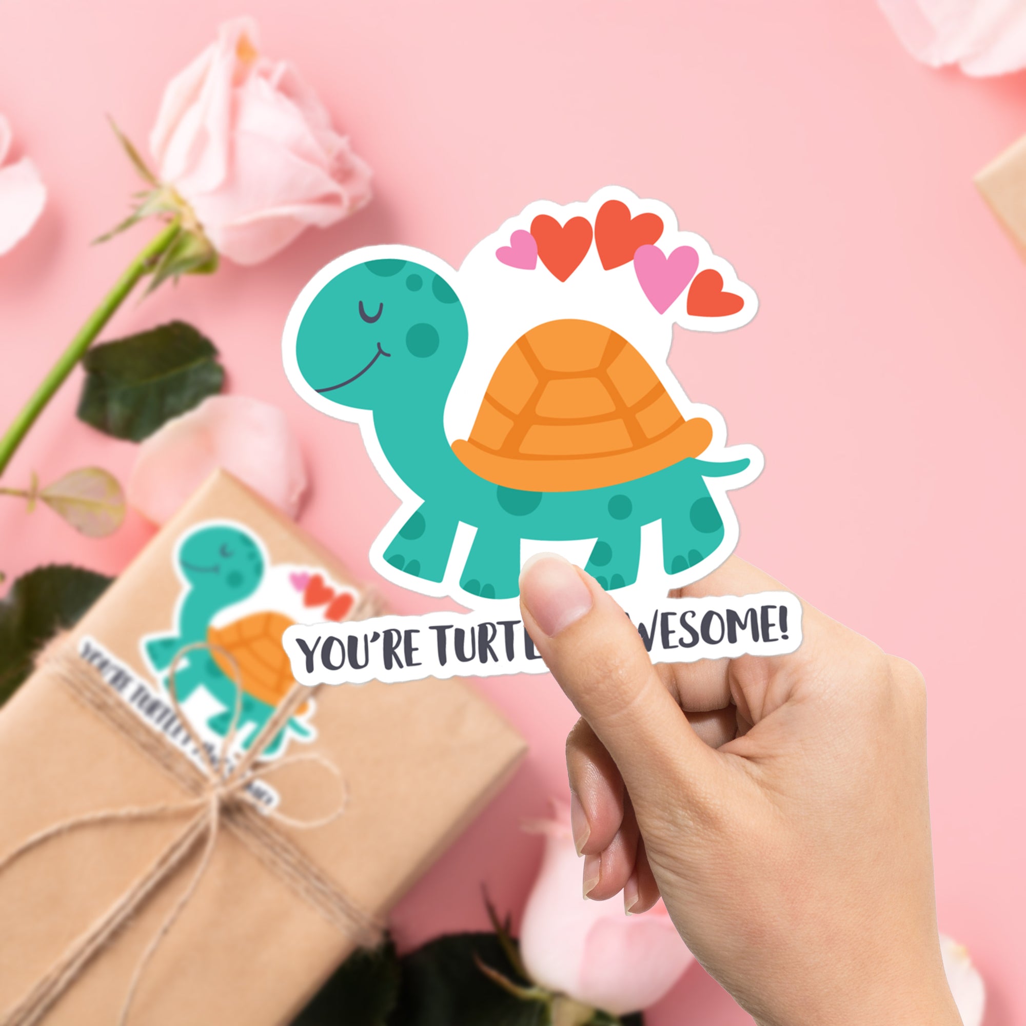a person holding up a turtle sticker