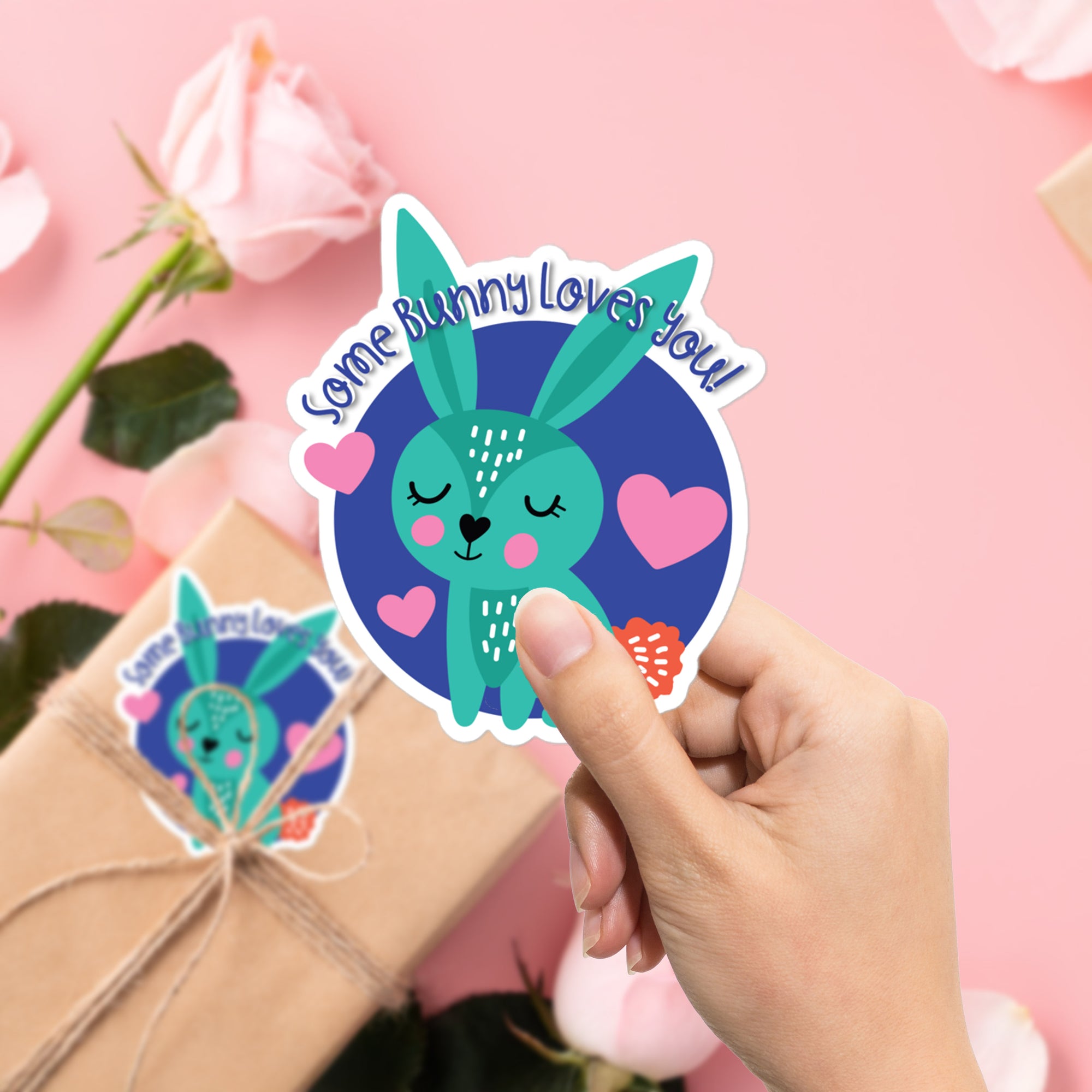 a person holding up a sticker with a bunny on it