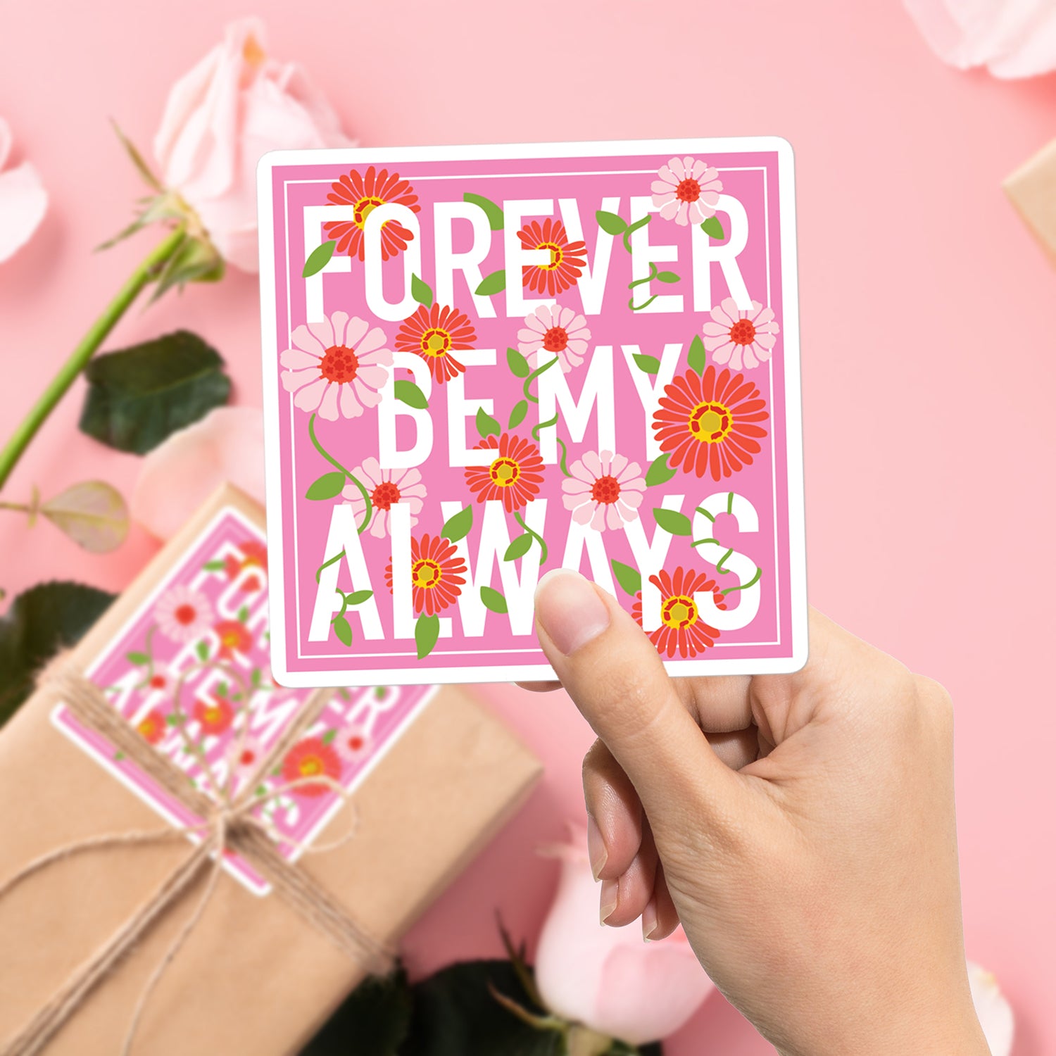 a person holding up a card with flowers on it