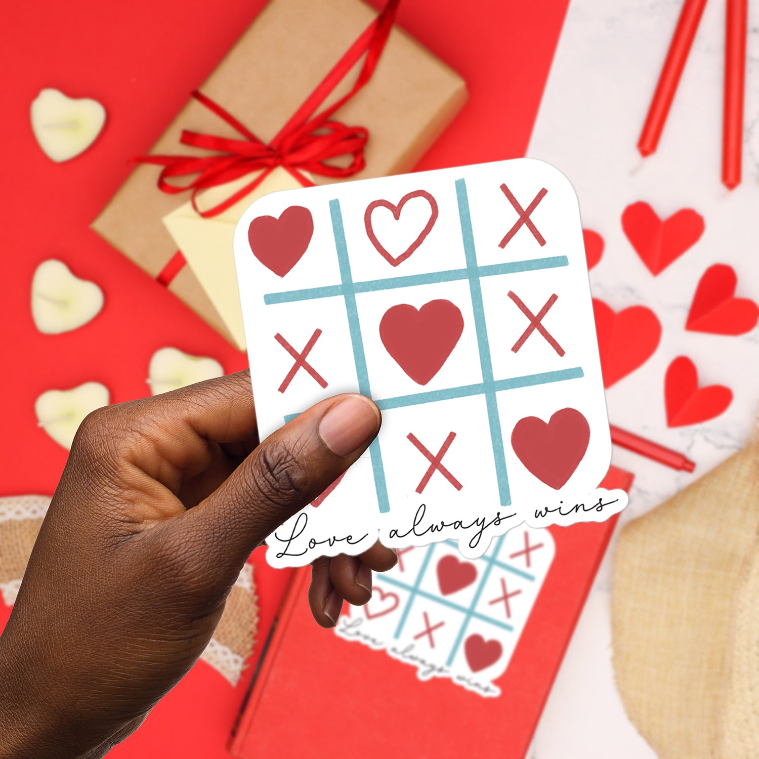 a person holding up a card with hearts on it