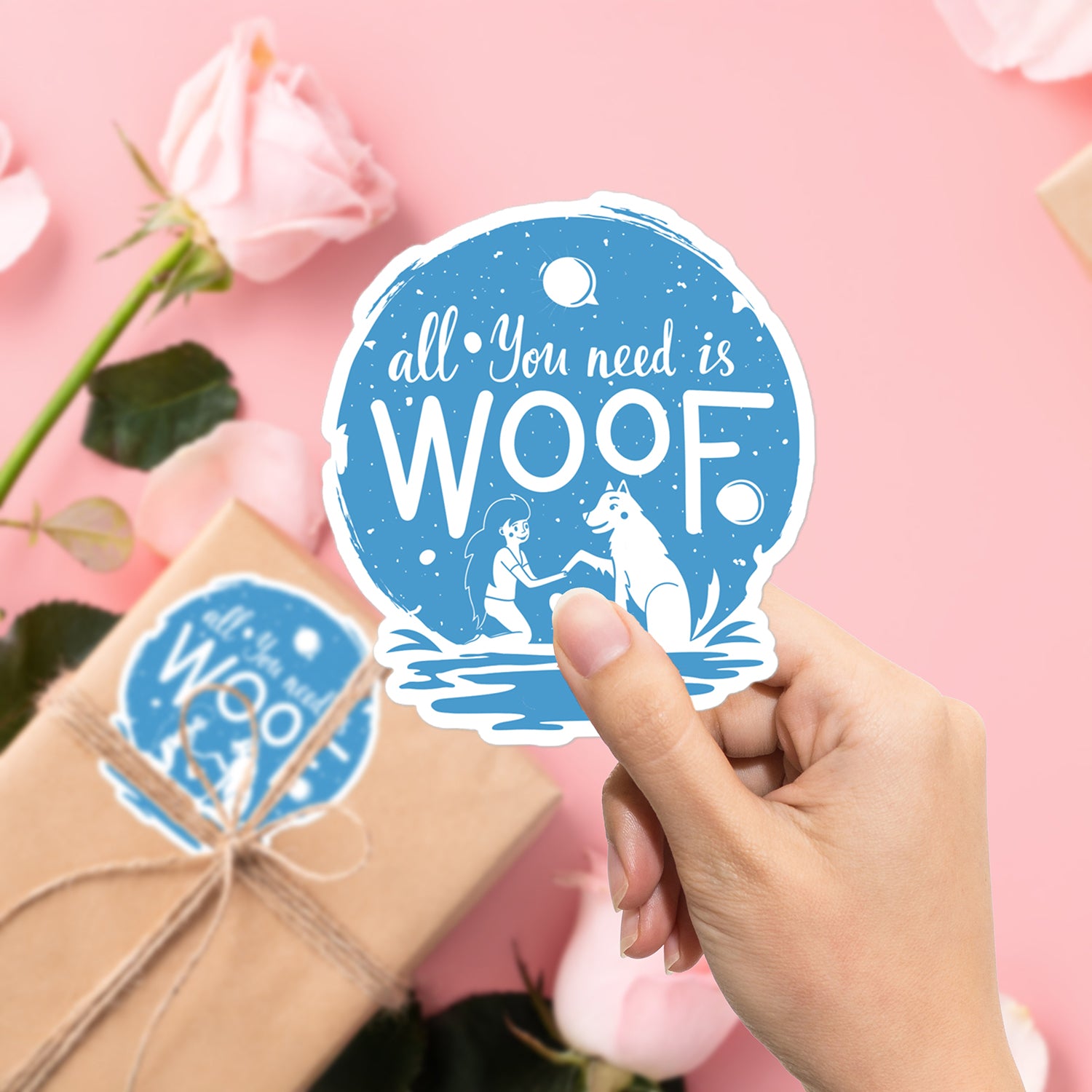 a hand holding a sticker that says, all you need is woof