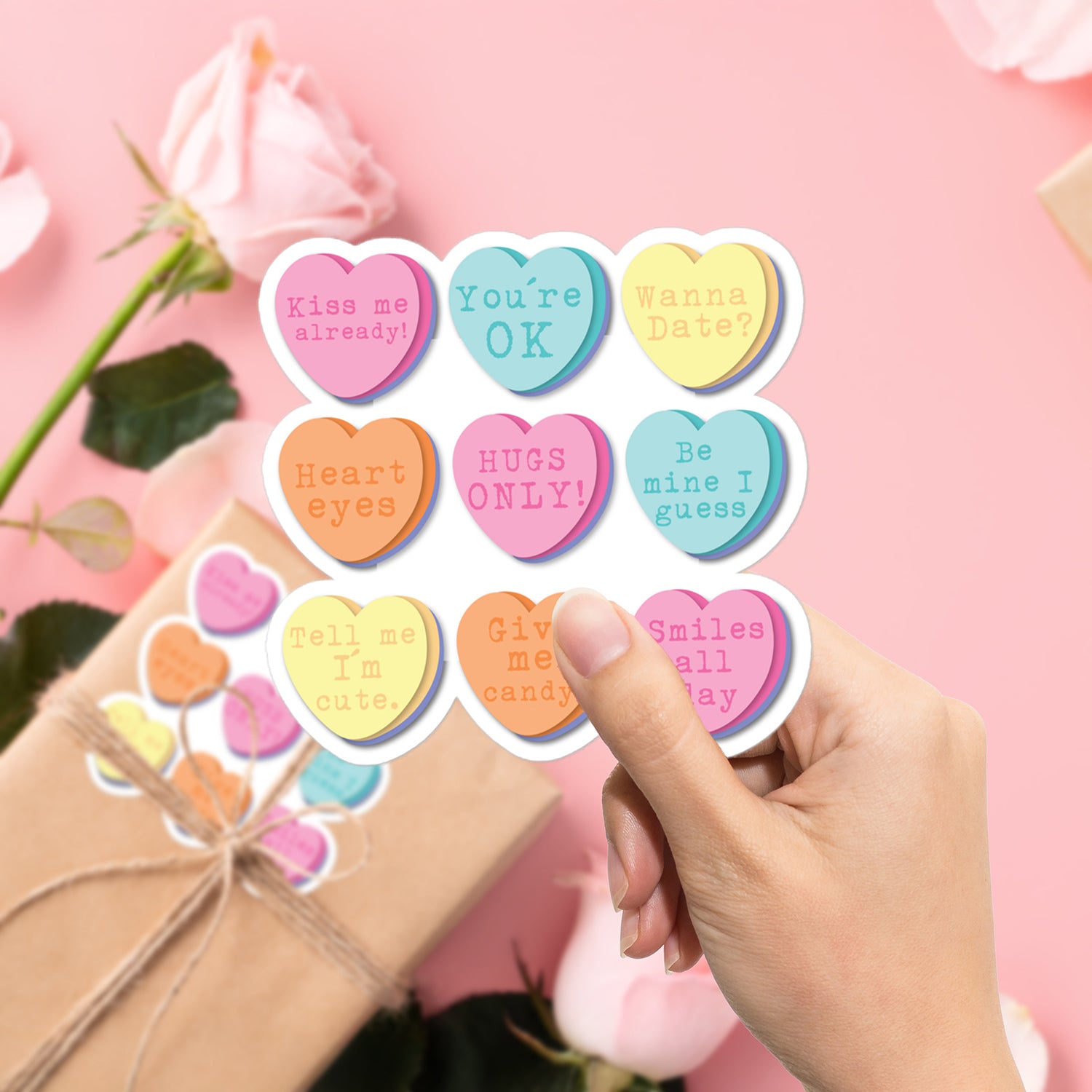 a person holding up a heart shaped sticker