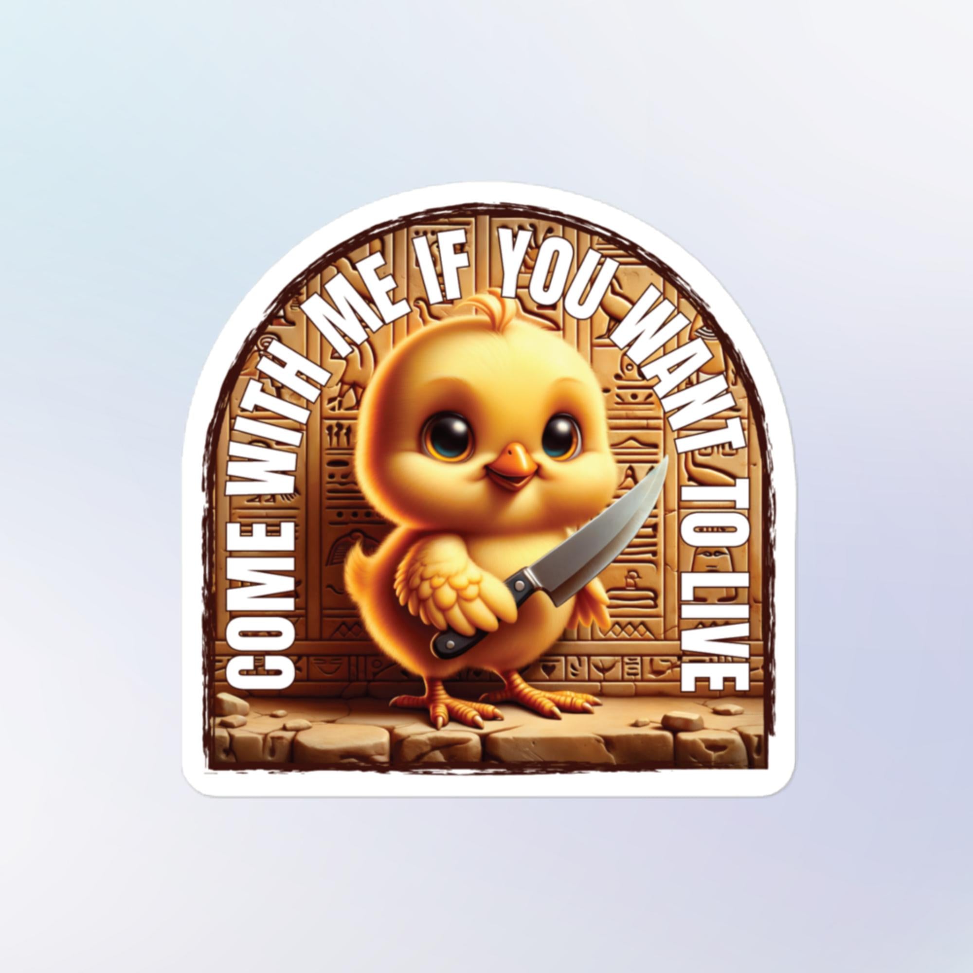 Sticker shape: Round arch. Design: A cute and fuzzy yellow chick with a sweet face is standing in front of a wall of hieroglyphics holding a large knife. Bold white text wrapped along the top of the sticker reads "COME WITH ME IF YOU WANT TO LIVE"