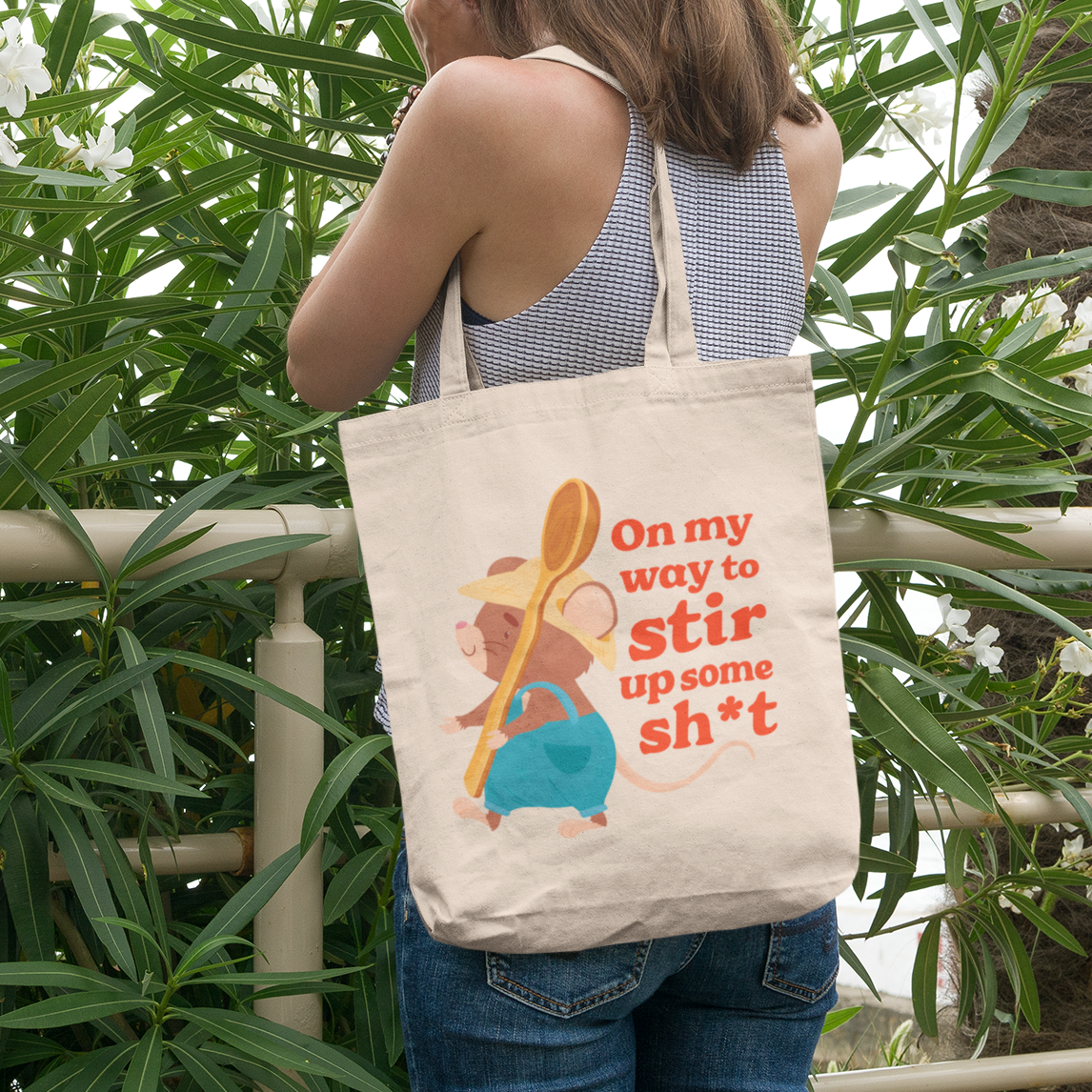 a woman carrying a tote bag that says on my way to stir up some