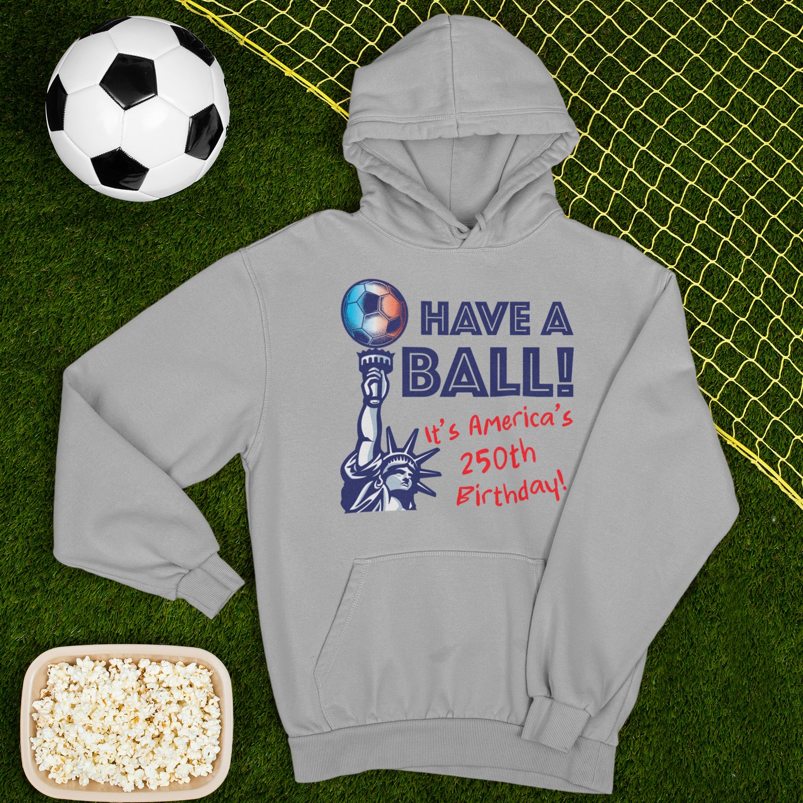 a hoodie and a bowl of popcorn on a soccer field