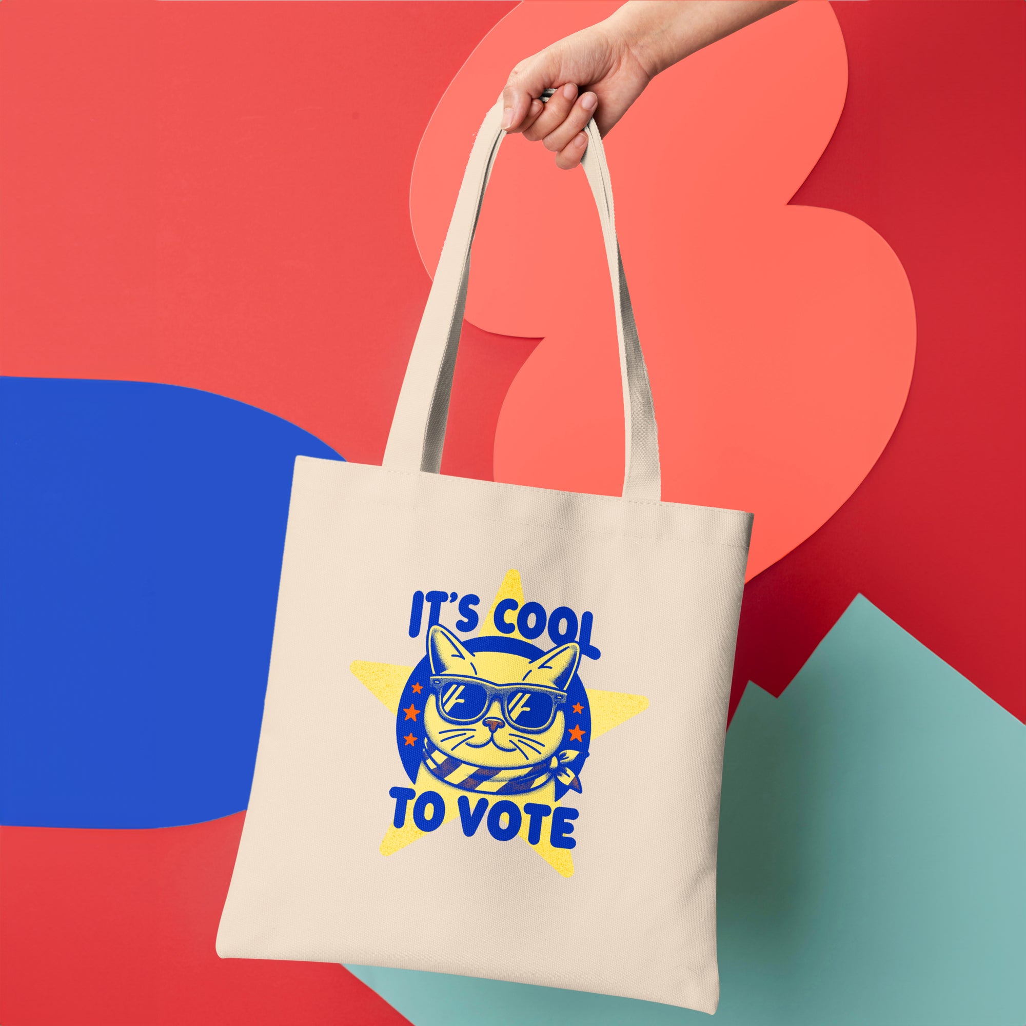 a person holding a tote bag that says it's cool to vote