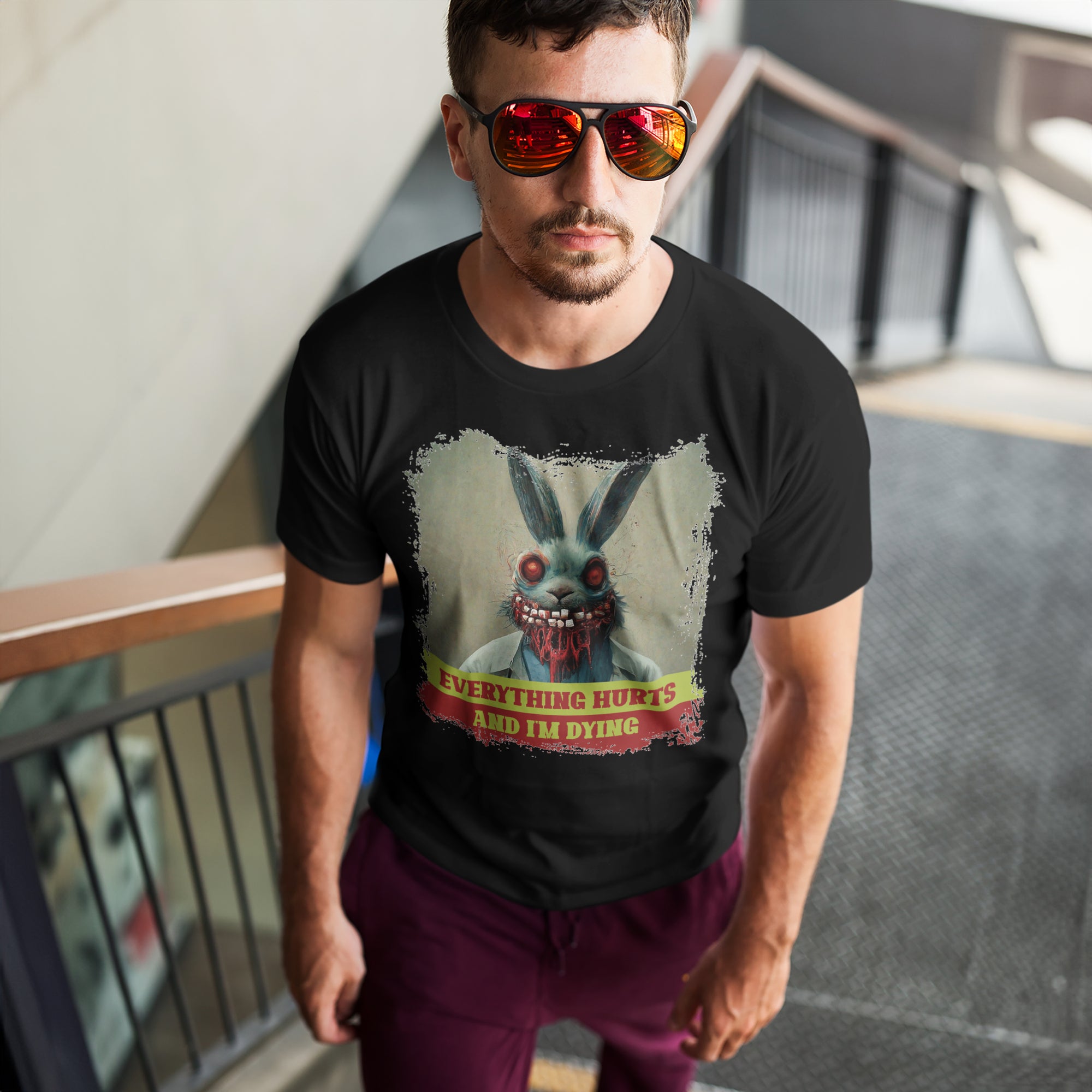 a man wearing a black shirt with a picture of a rabbit on it