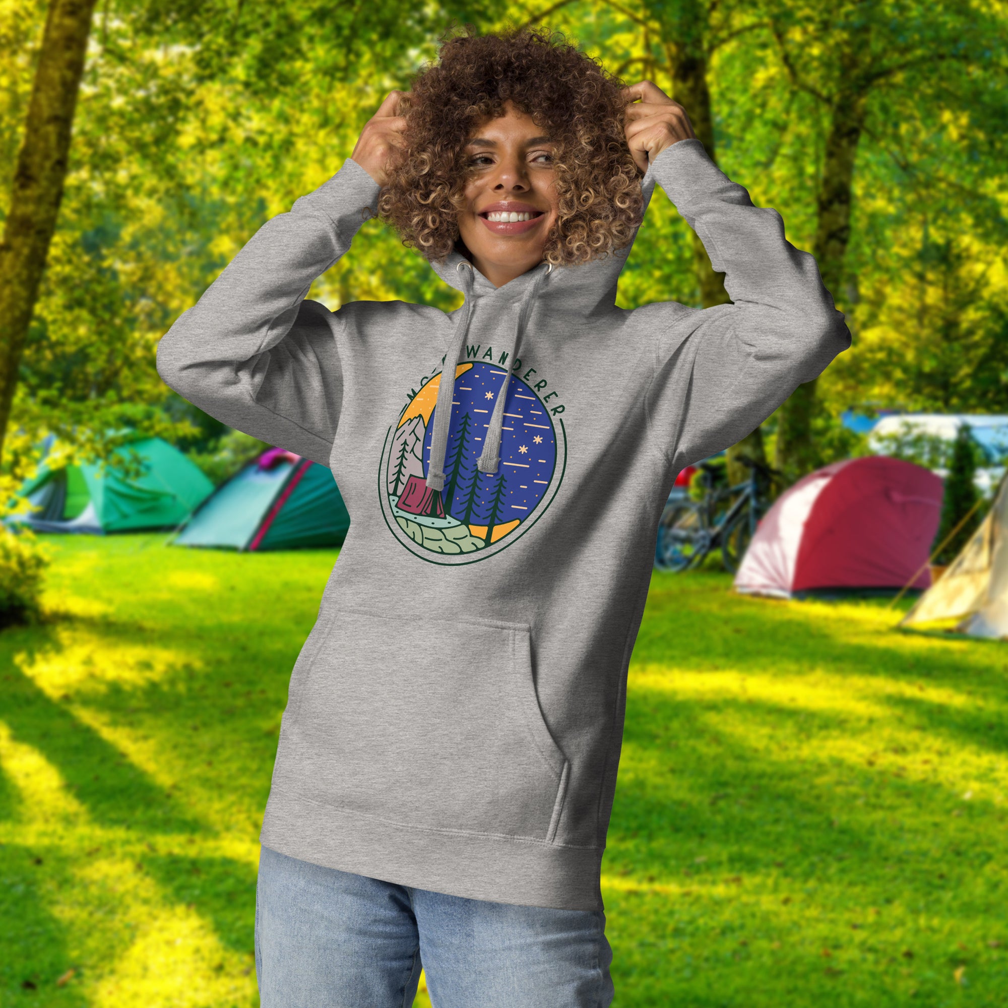 a woman standing in a field with a hoodie on