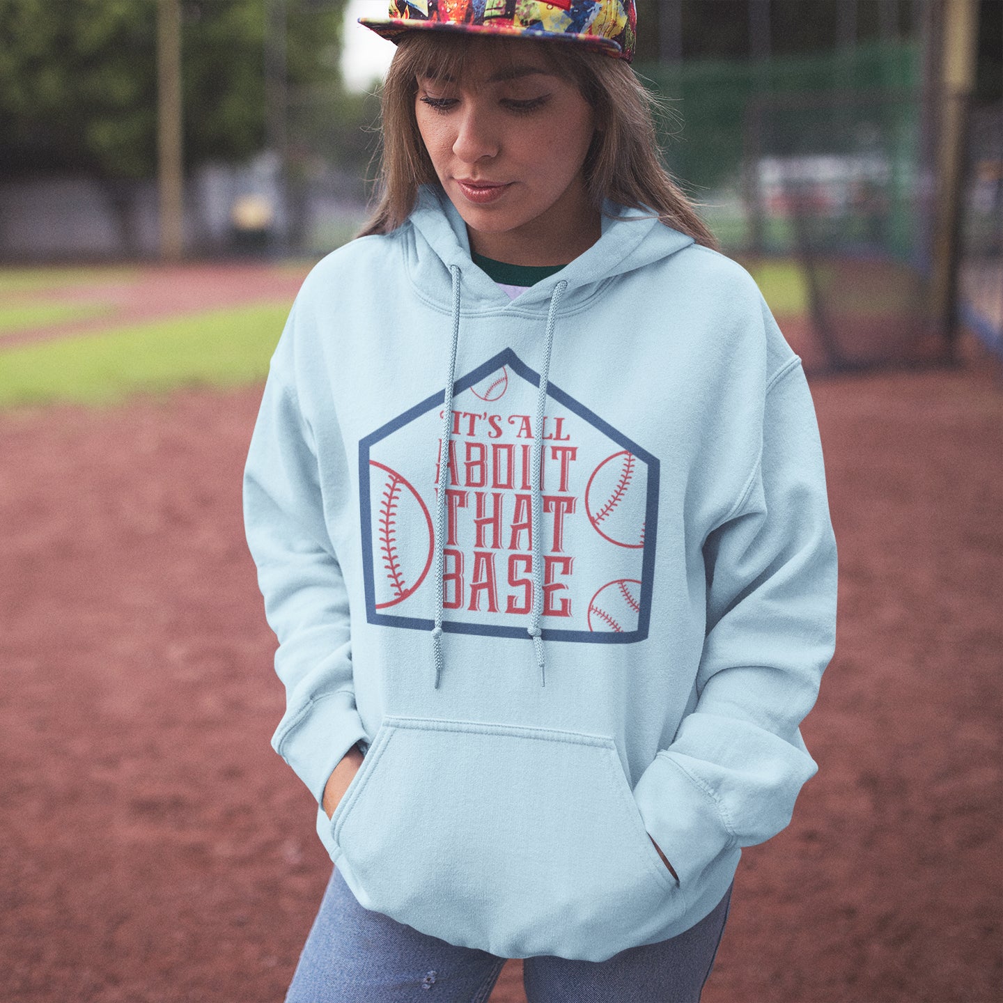 a girl wearing a baseball hat and a sweatshirt