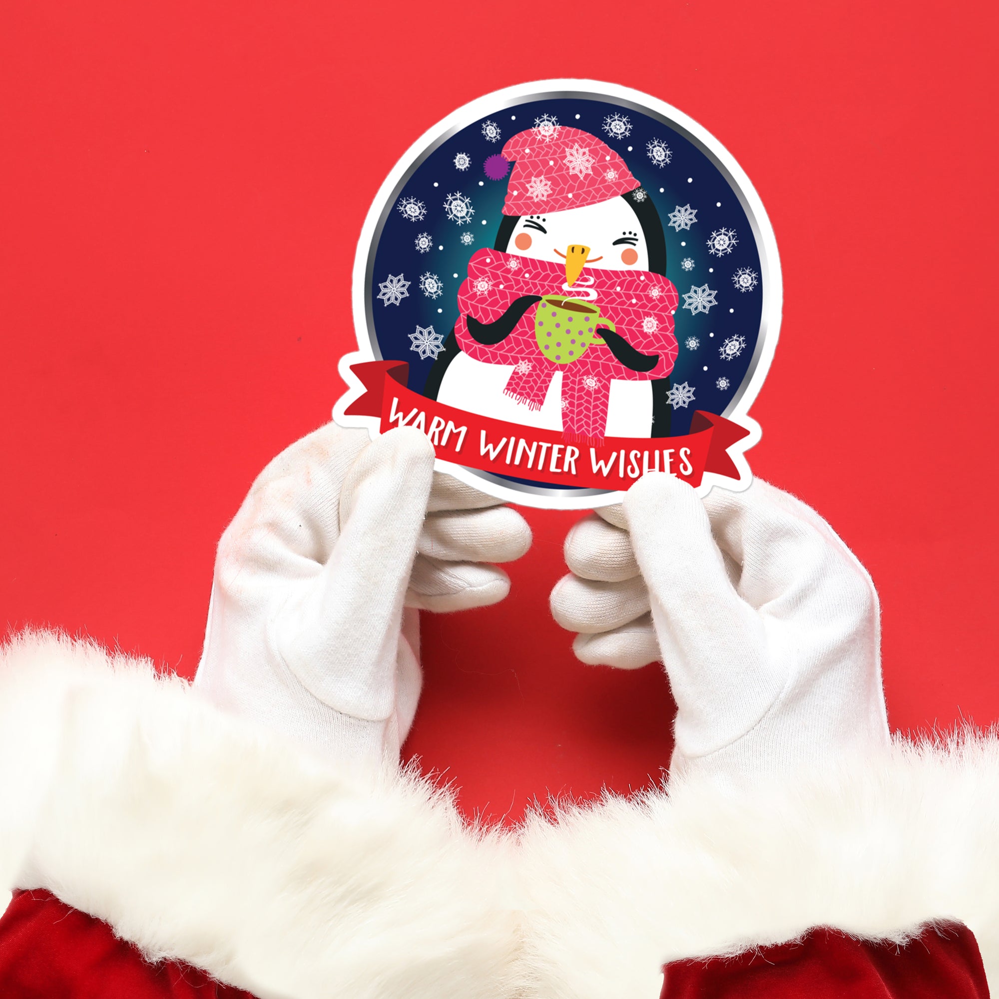 a person in a santa suit holding up a sticker