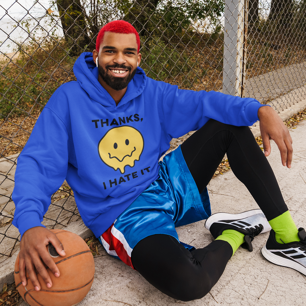 a man sitting on the ground with a basketball