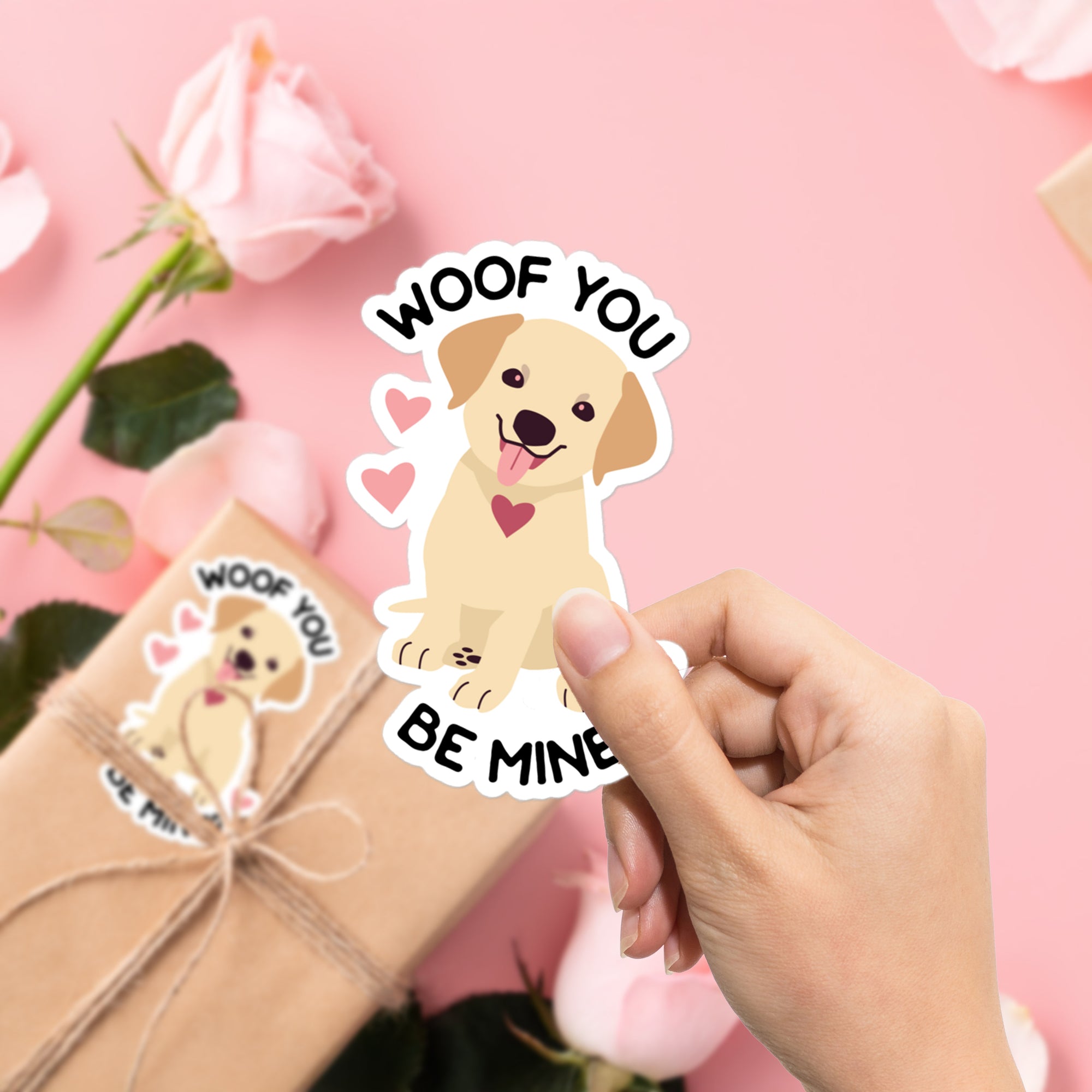 a hand holding a sticker that says woof you be mine