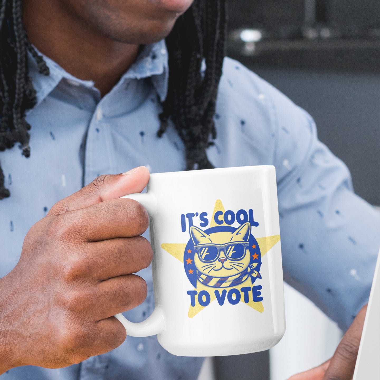 a man with dreadlocks holding a coffee mug