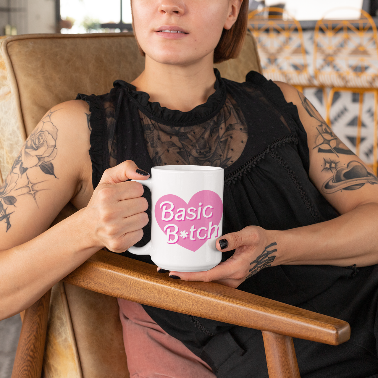 a woman sitting in a chair holding a coffee mug