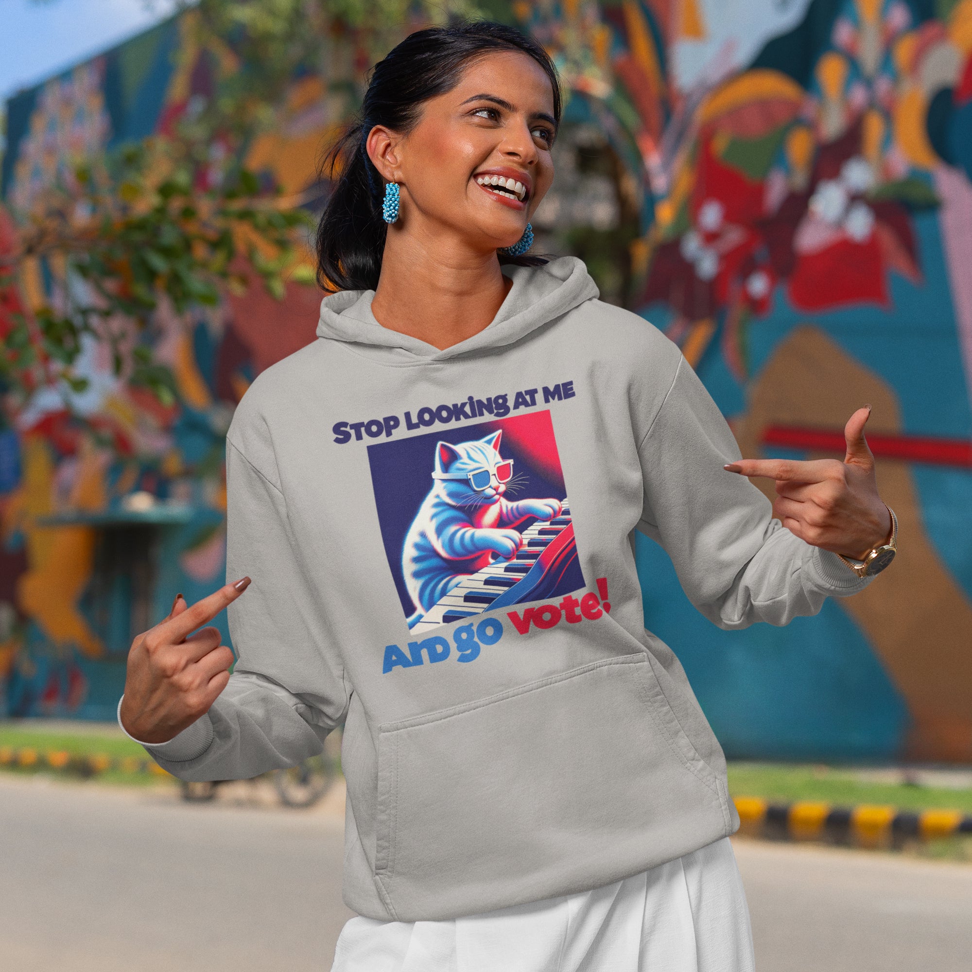 a woman in a gray hoodie pointing at something