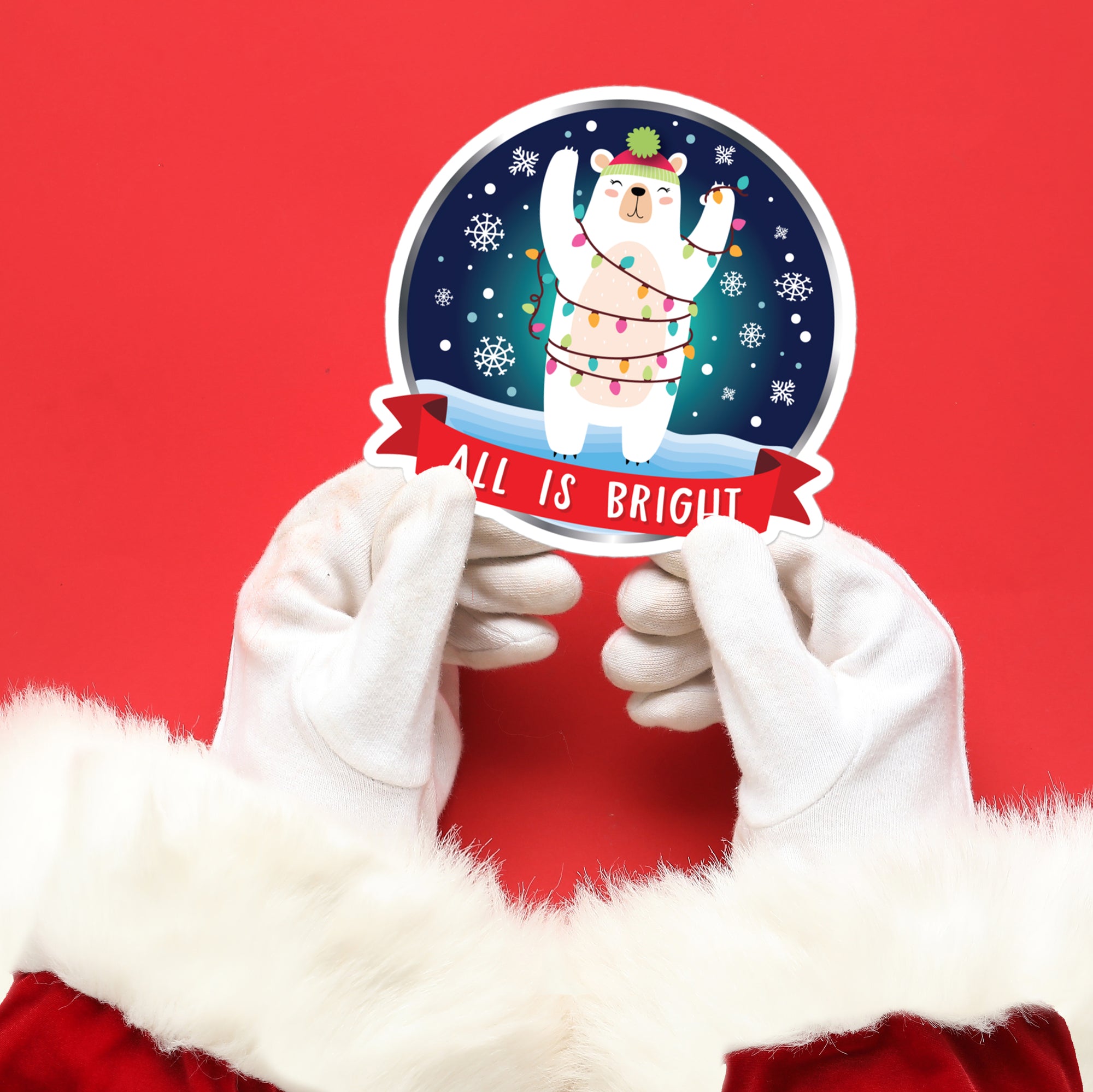 a person in a santa suit holding up a sticker