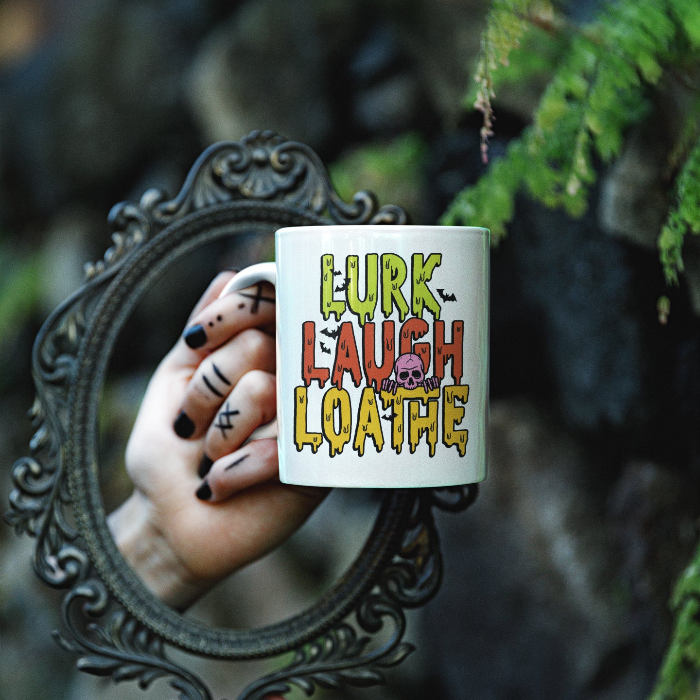 a hand holding a coffee mug with the words lurk laugh loathfe on