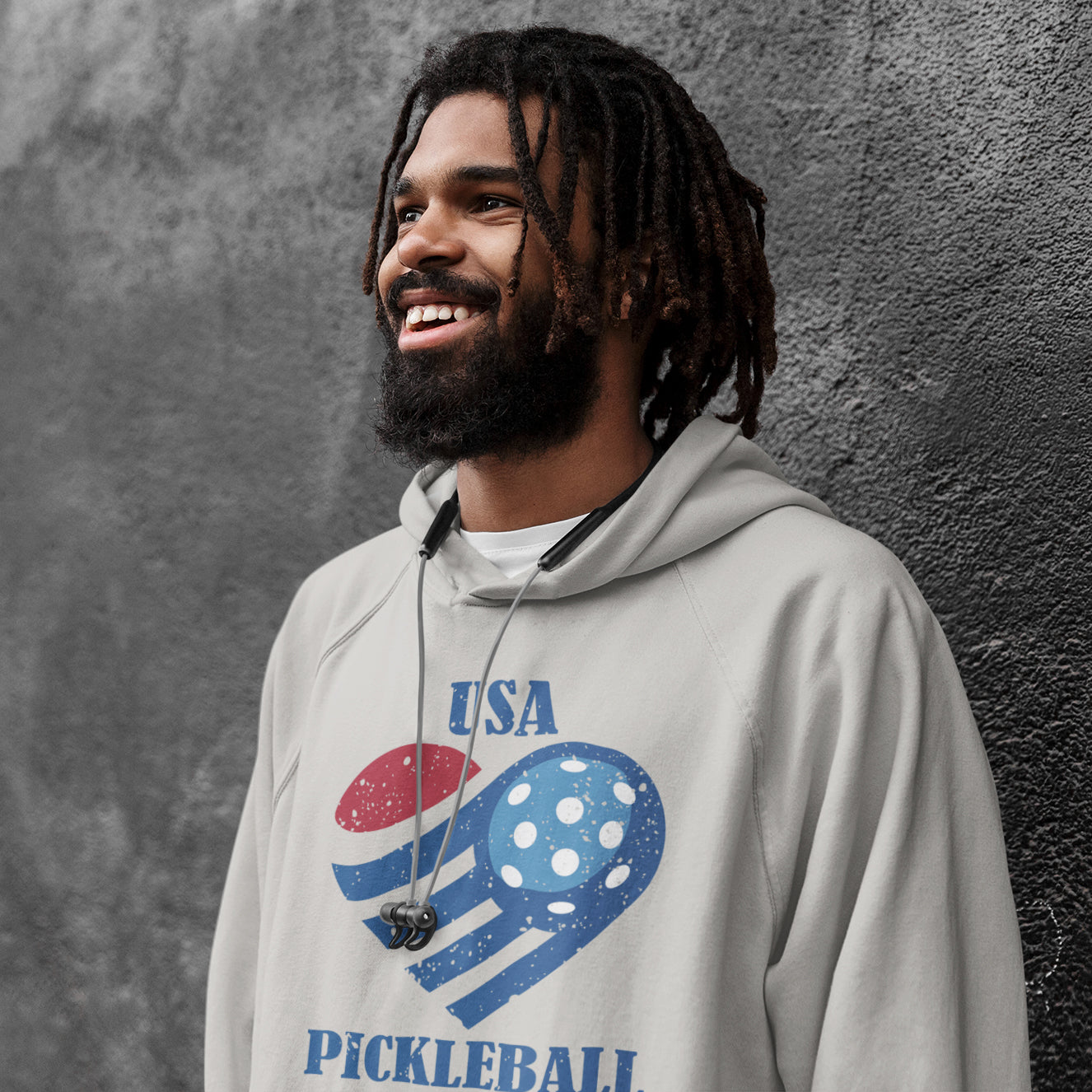 a man with dreadlocks wearing a usa pickleball hoodie