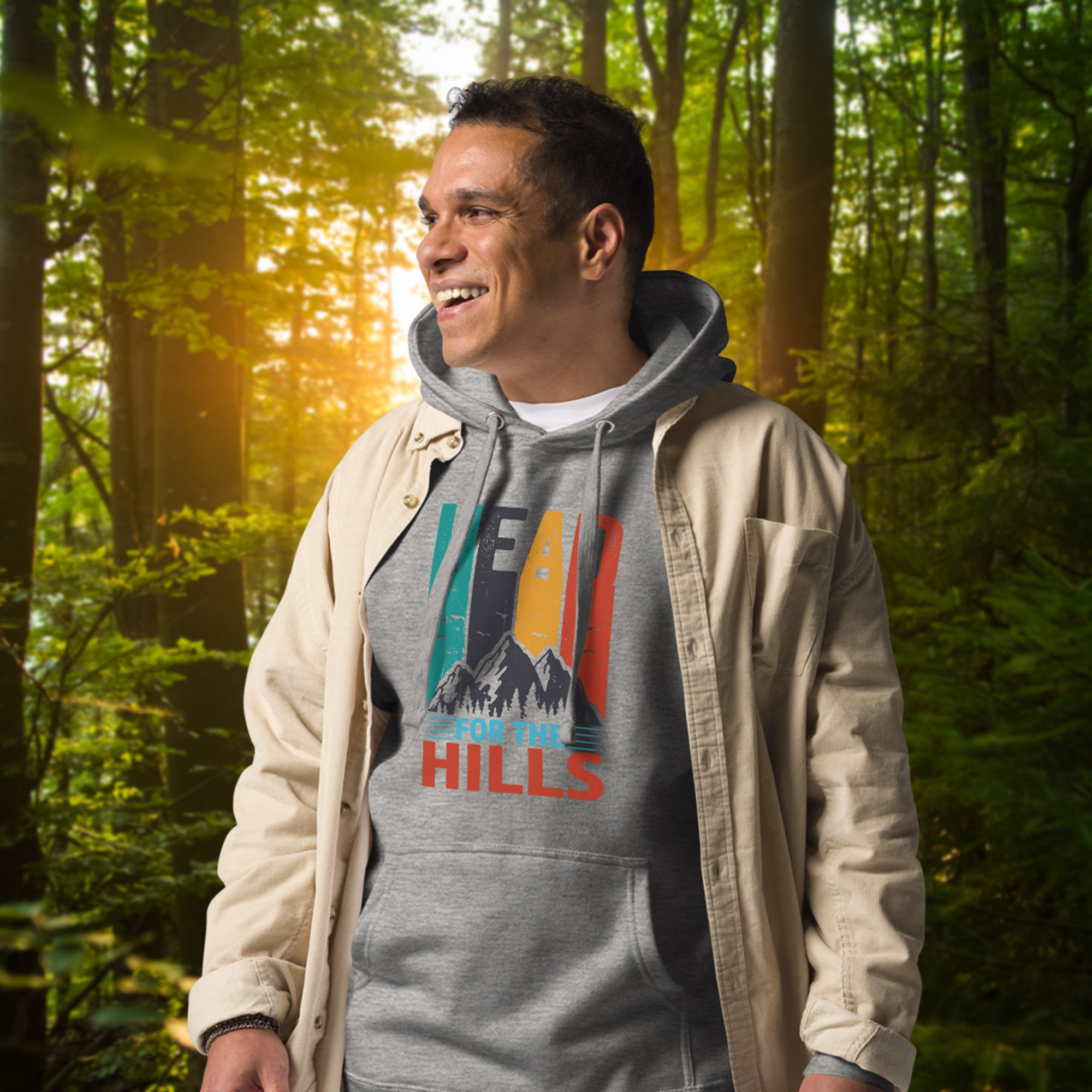 a man standing in the woods wearing a hoodie