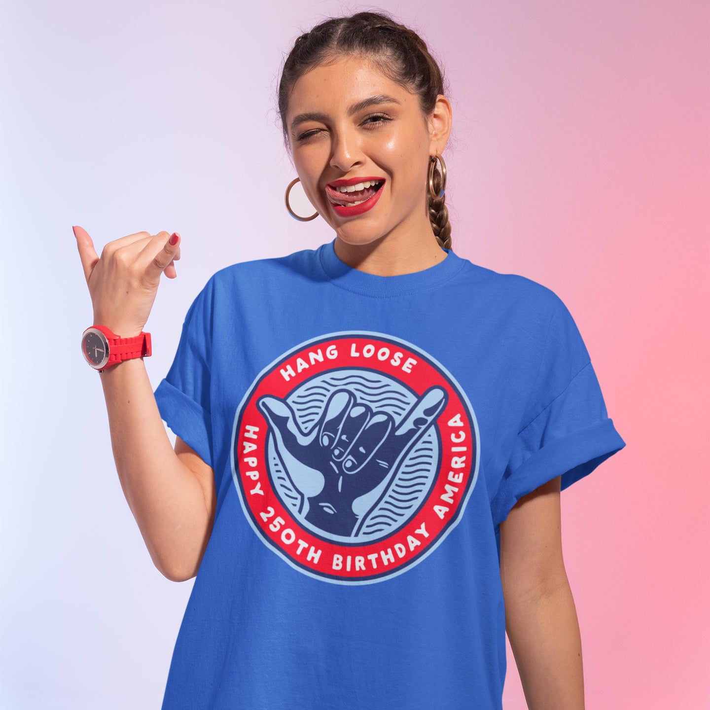 a woman wearing a blue t - shirt with a pink background