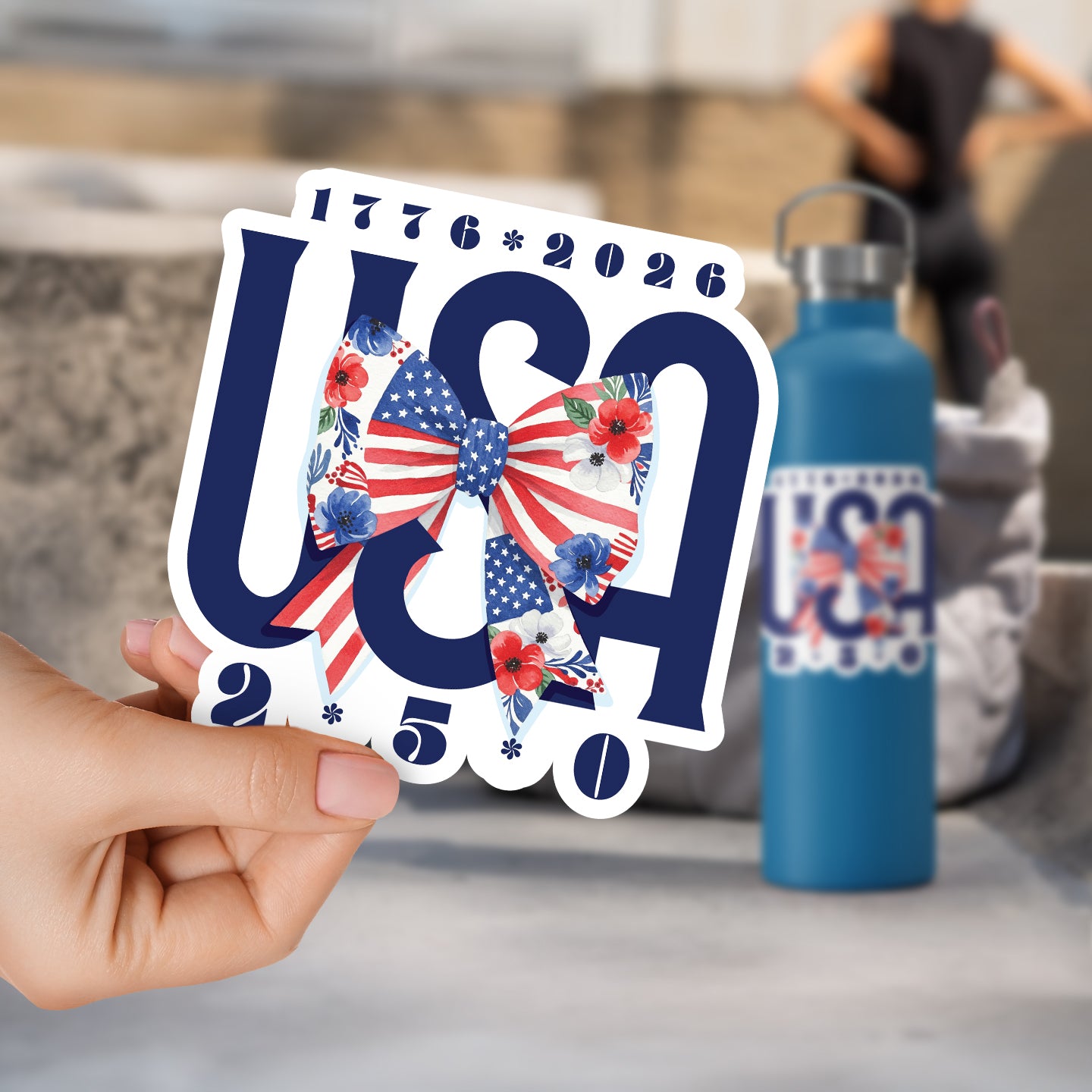 a person holding up a sticker with a bow on it