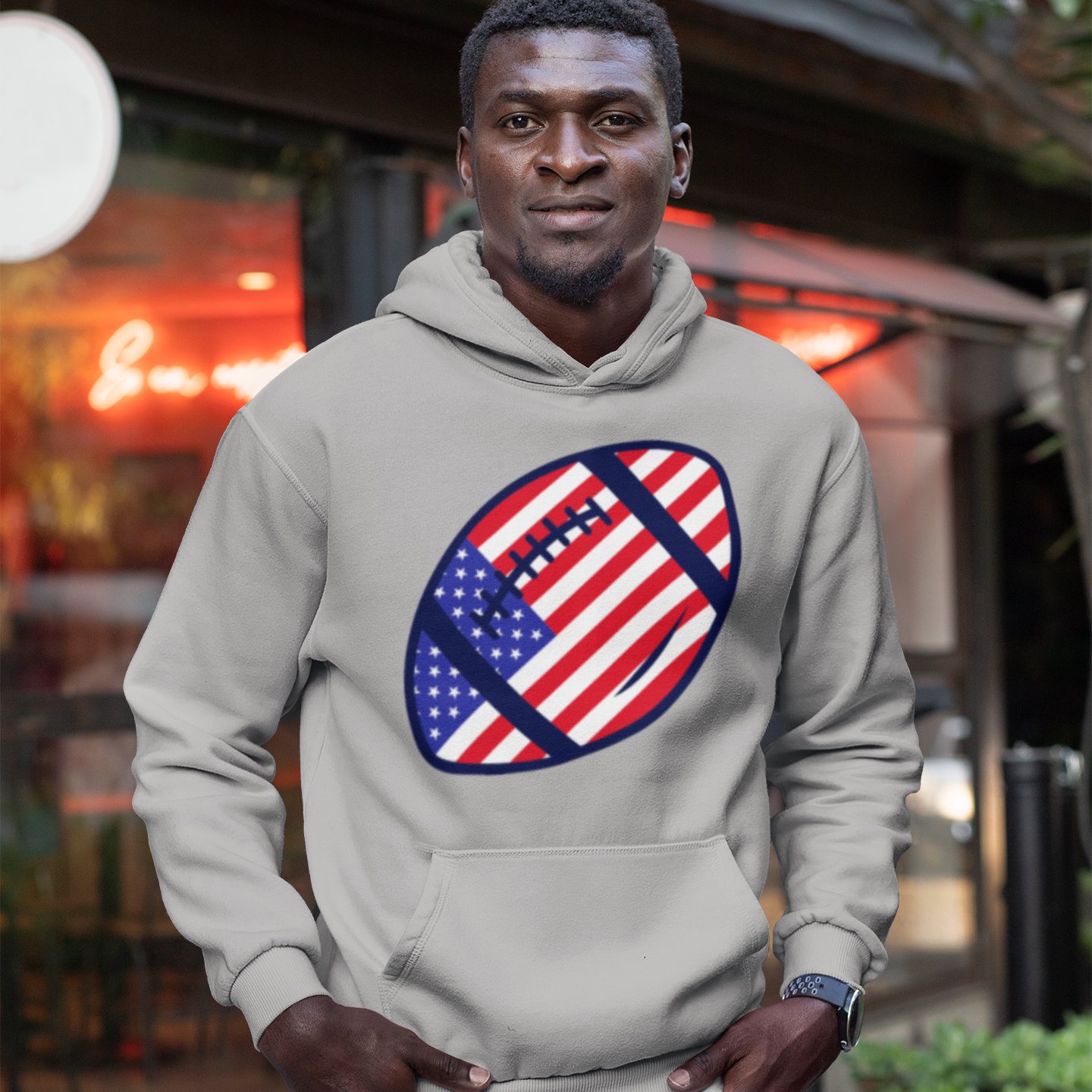 a man wearing a hoodie with an american flag on it