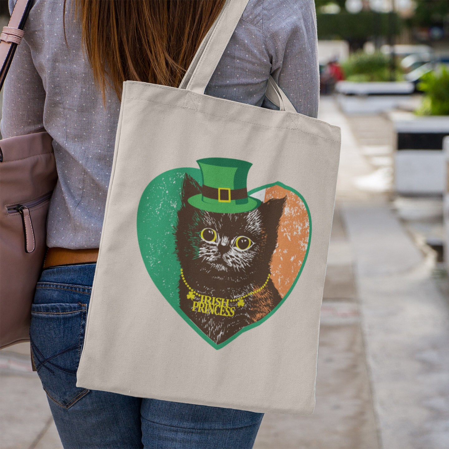 a woman carrying a bag with a picture of a cat on it