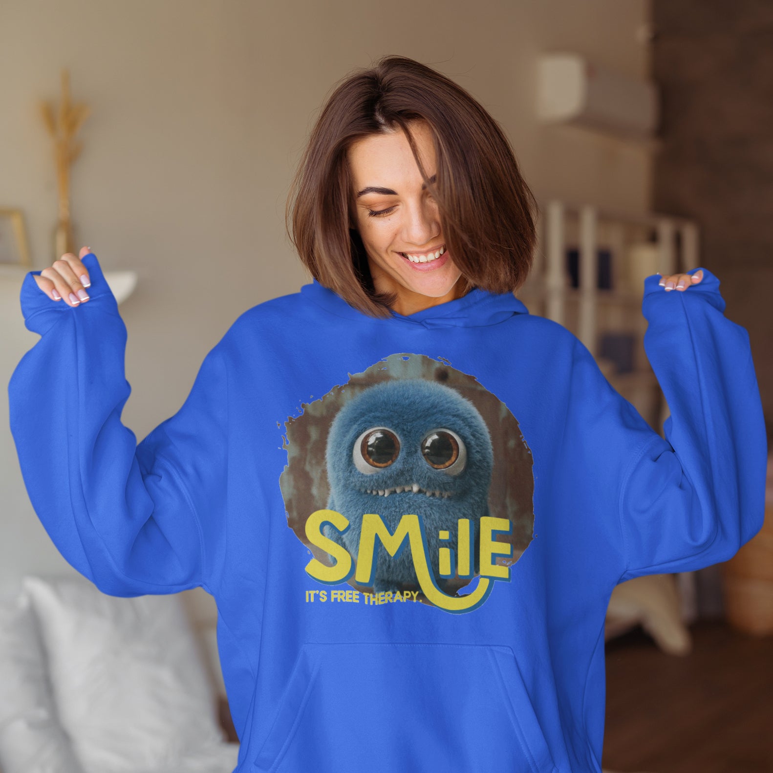 a woman in a blue hoodie with a smile on her face