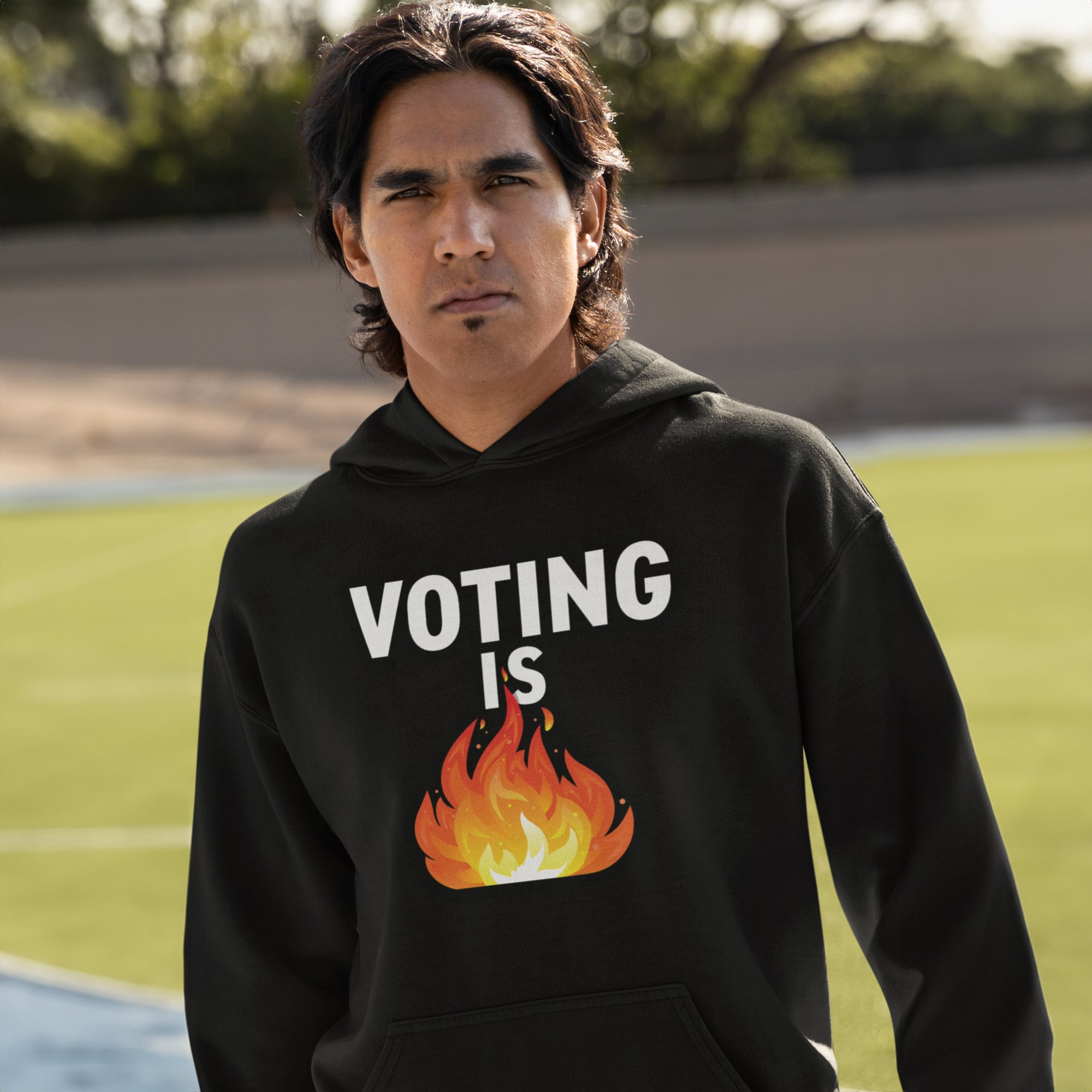 a young man wearing a black hoodie with a fire on it