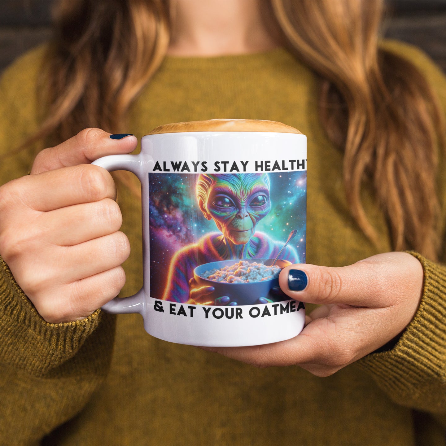 a woman holding a coffee mug with a picture of an alien on it