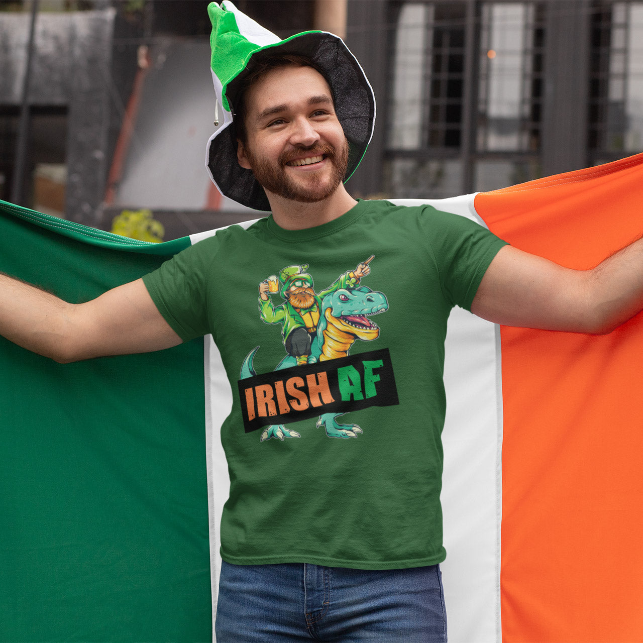 a man in a green shirt holding a flag and a green hat