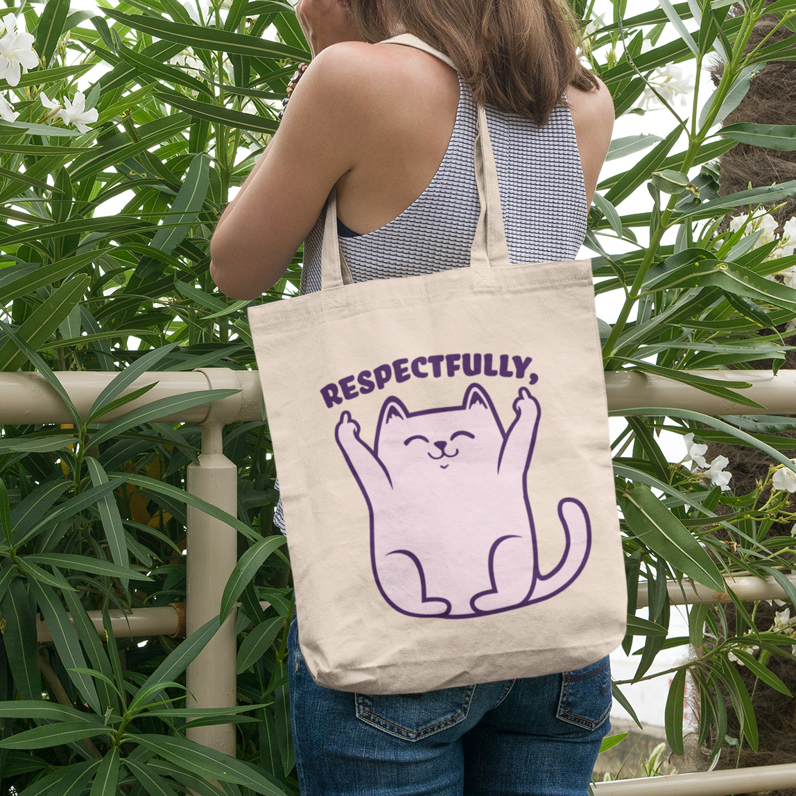 a woman carrying a tote bag with a cat on it