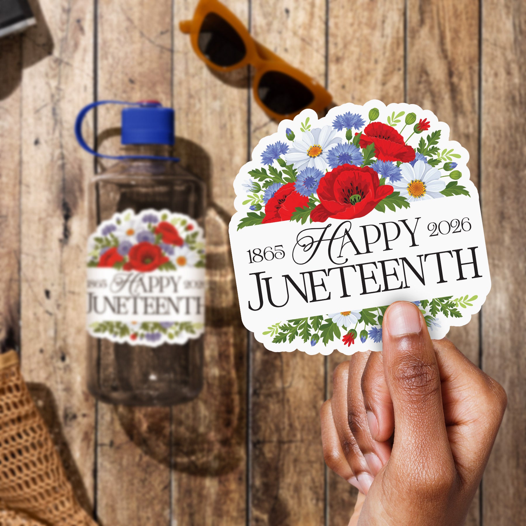 a person holding up a happy juneteeth sticker