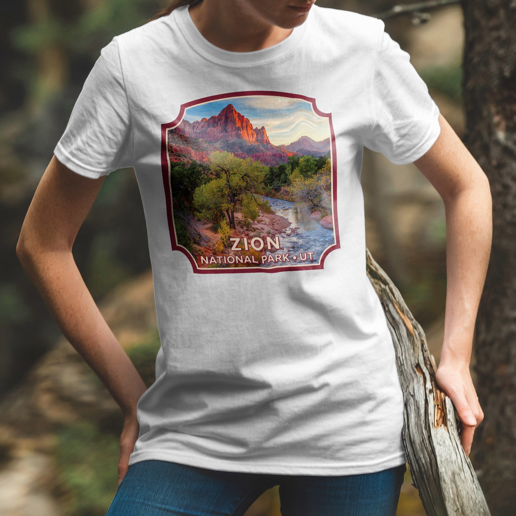 a woman wearing a white t - shirt with a picture of a mountain