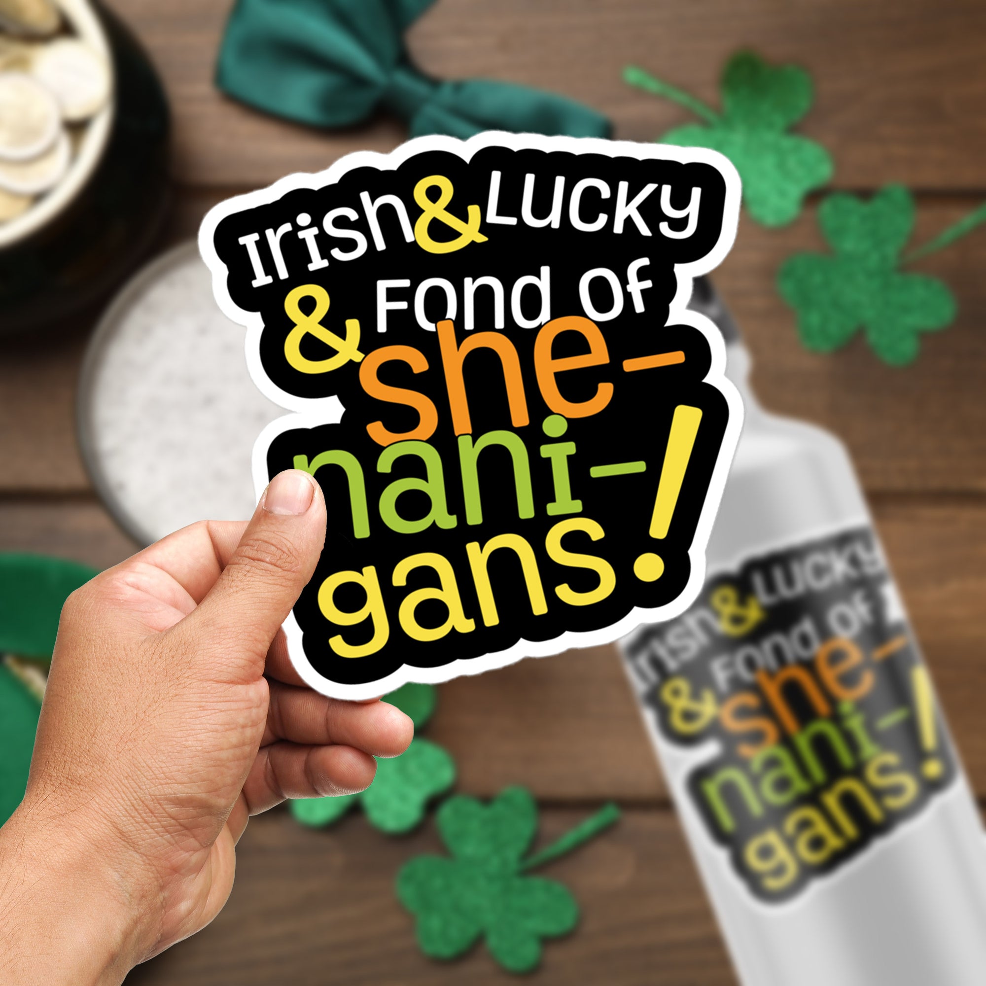 a hand holding a sticker that says irish and lucky