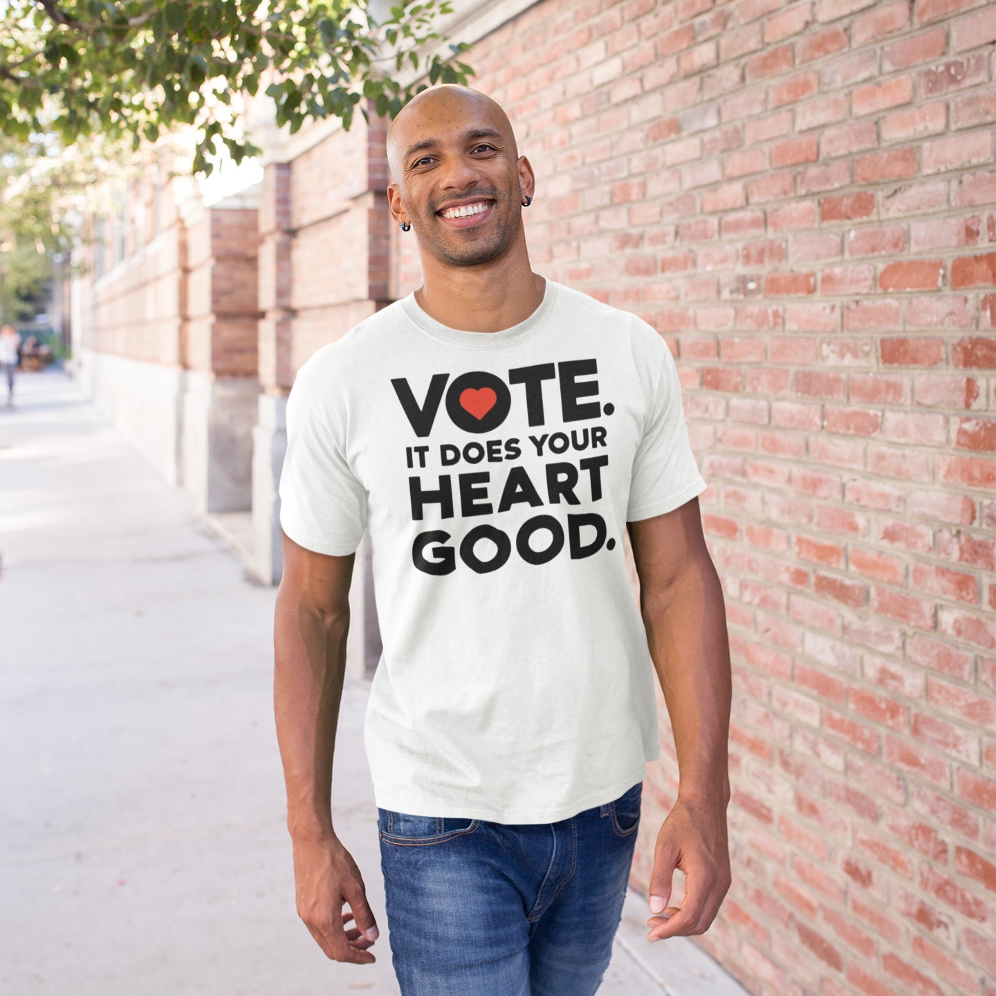 a man wearing a vote it does your heart good t - shirt