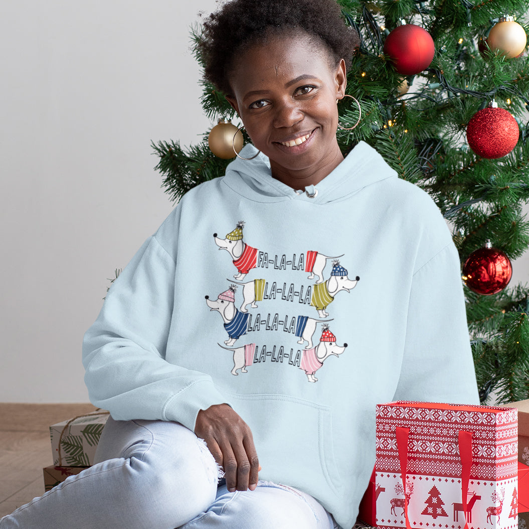 a woman sitting in front of a christmas tree