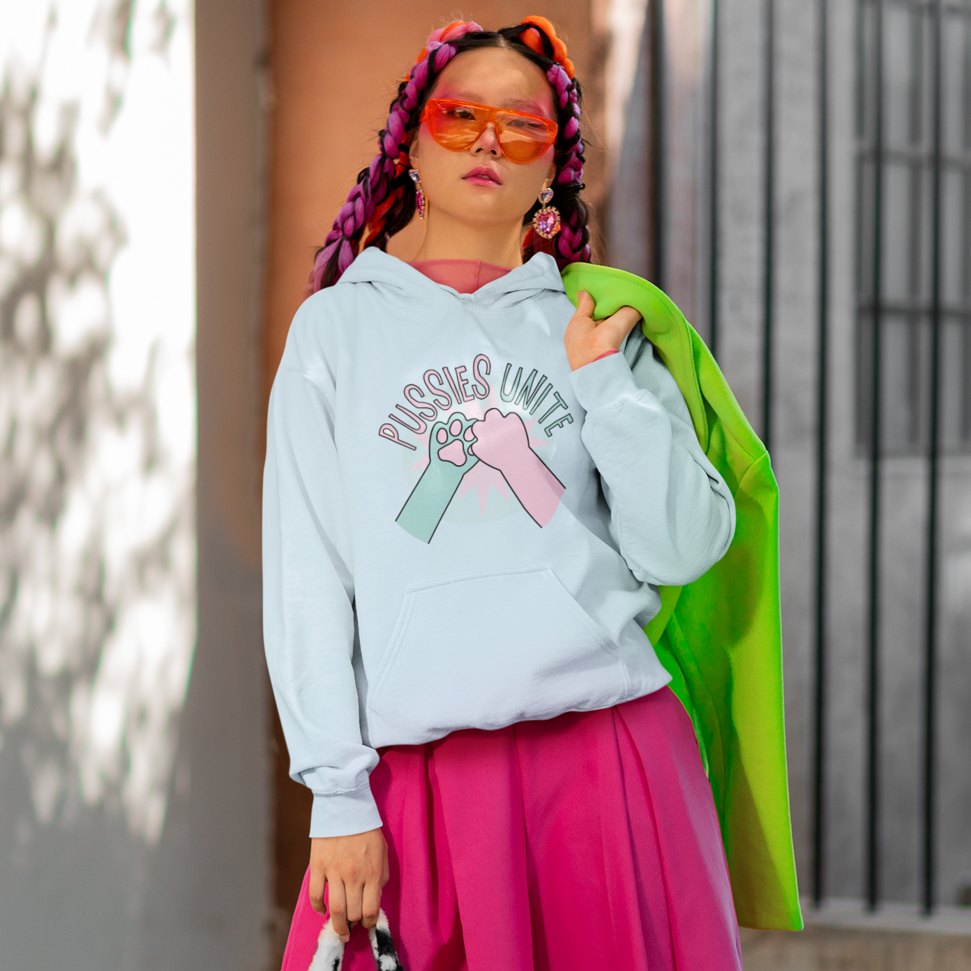 a woman in a white hoodie and pink skirt