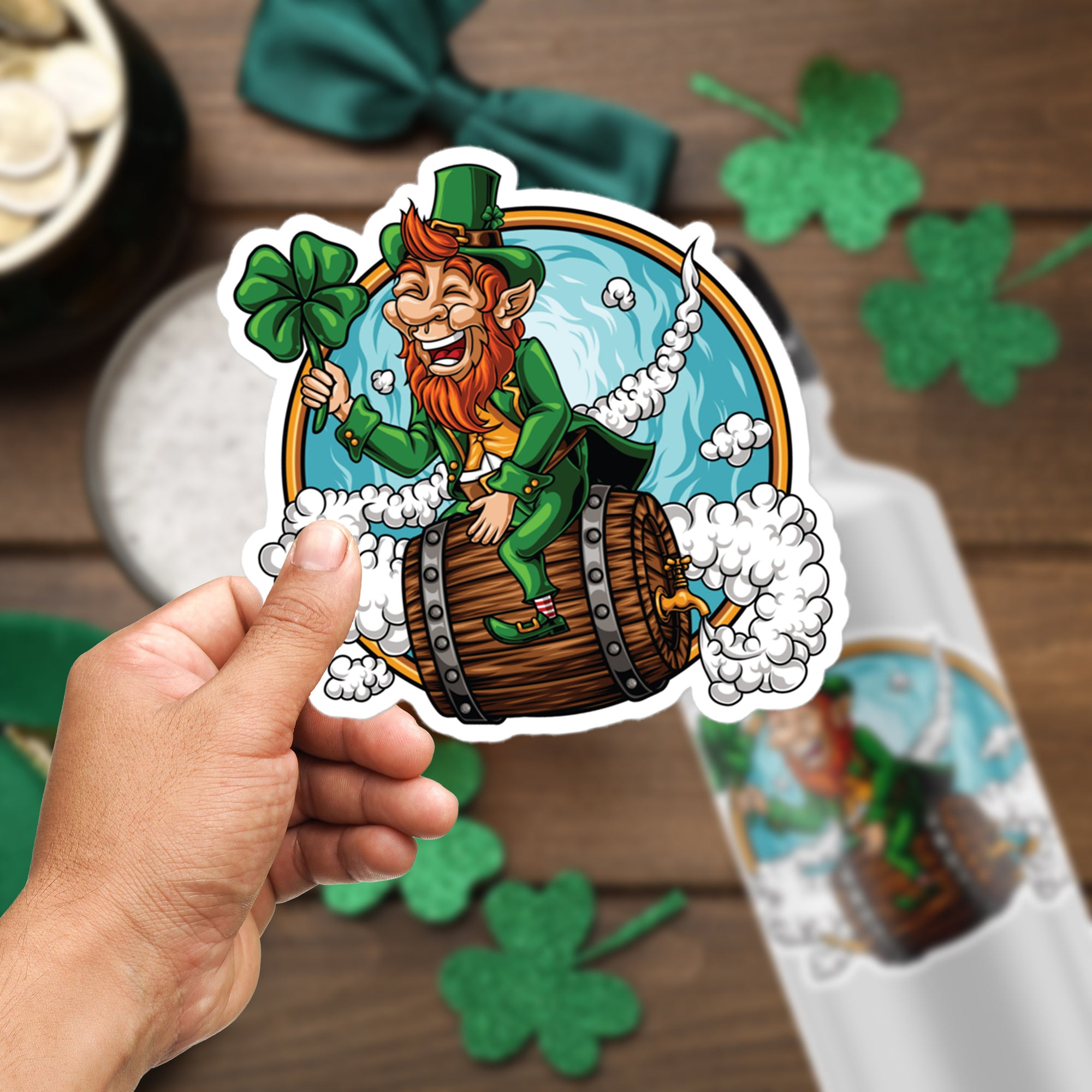 a hand holding a sticker of a leprechaun