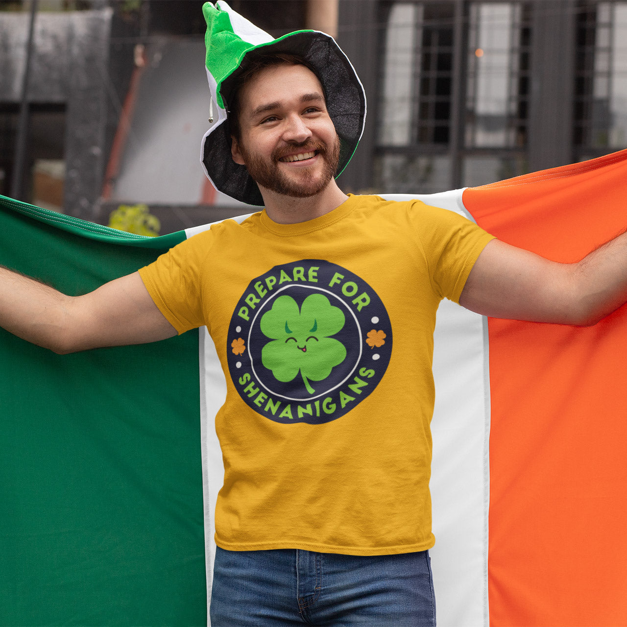 a man in a st patrick's day t - shirt holding a irish flag