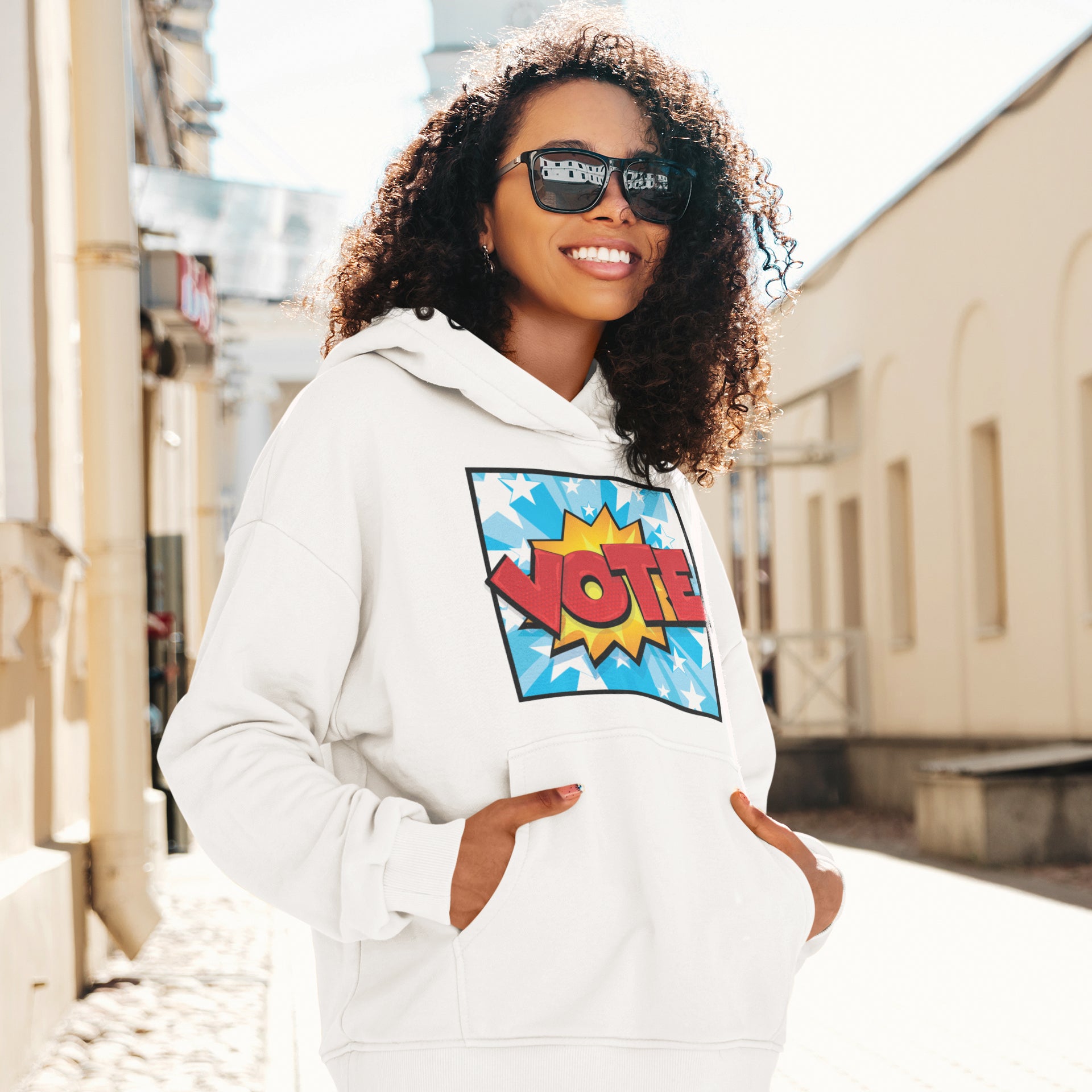 a woman wearing a white hoodie and sunglasses