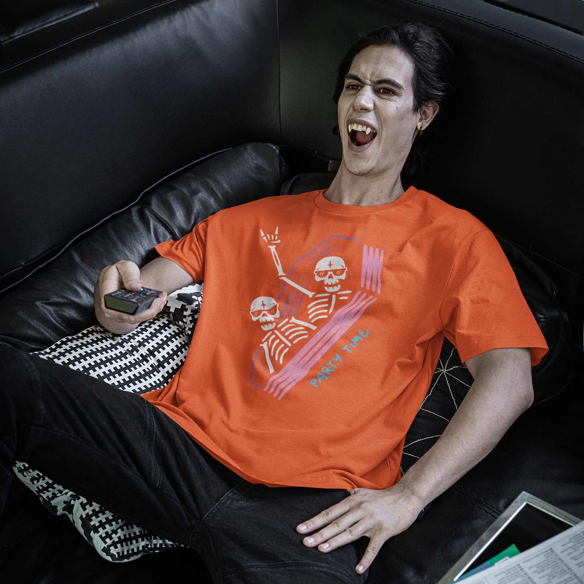 a man sitting on a couch with a cell phone in his hand