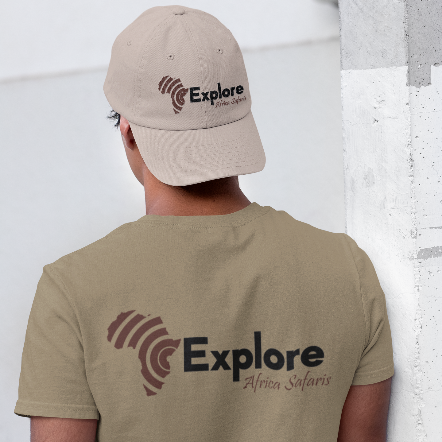 a man wearing a hat and a t - shirt that says explore