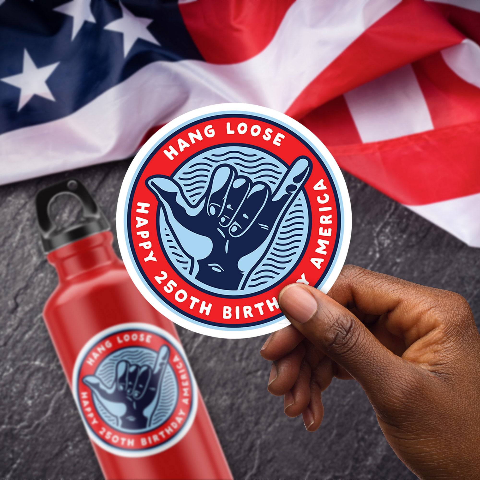 a person holding a sticker in front of an american flag