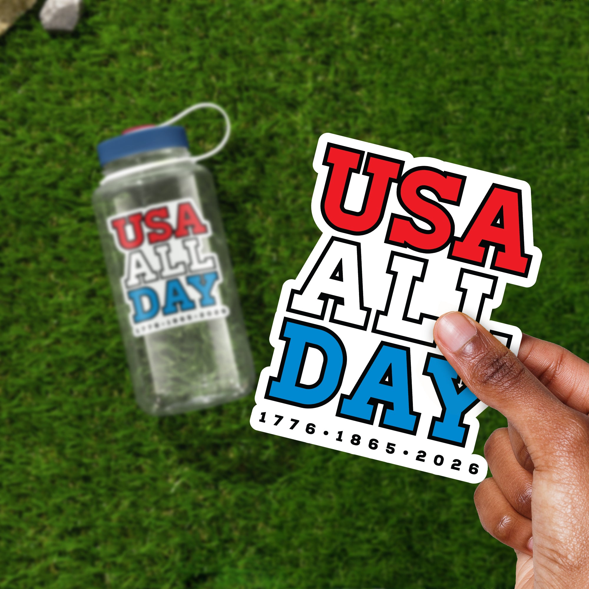 a person holding up a sticker that says usa all day