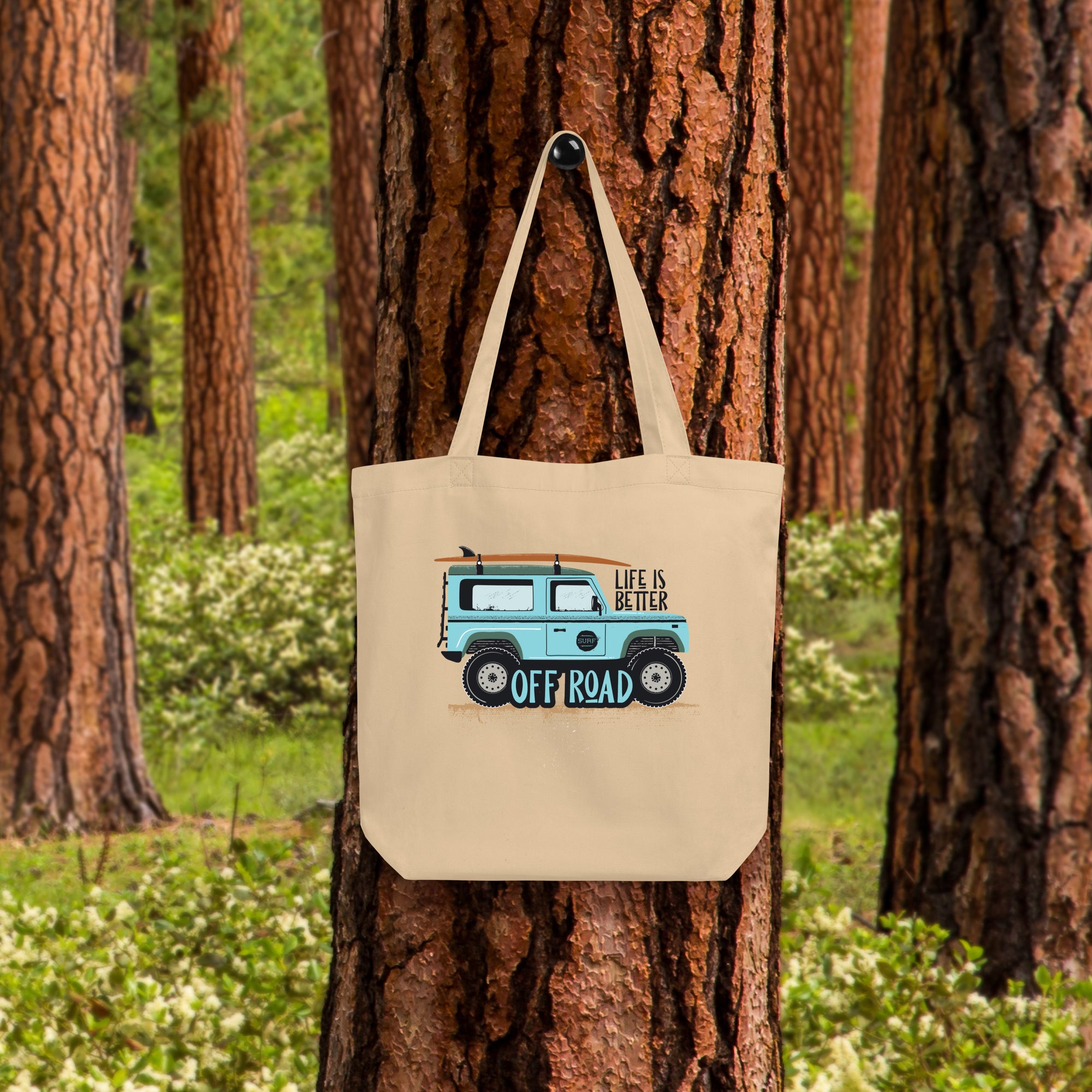 a tote bag hanging on a tree in the woods