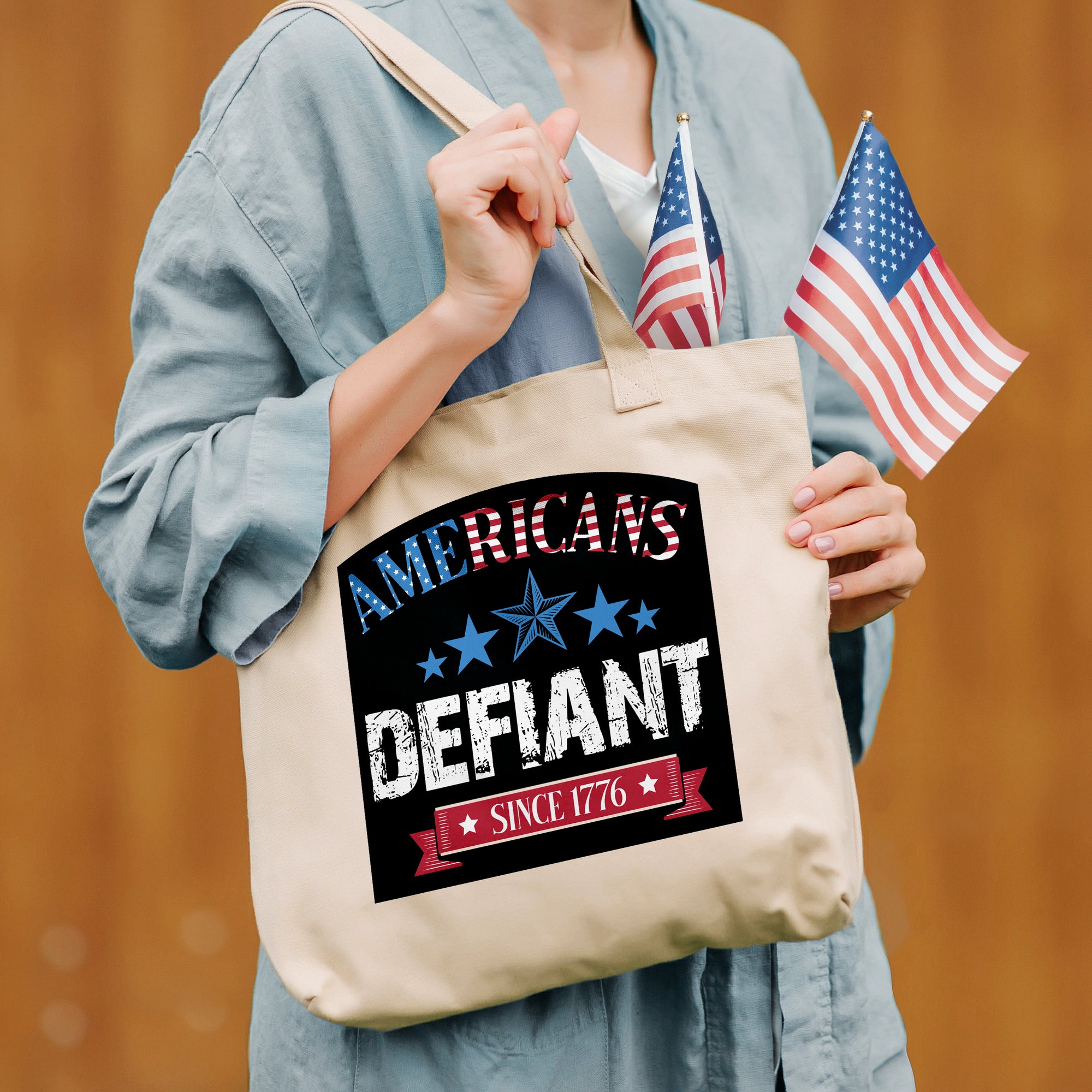 a woman holding a tote bag with an american flag