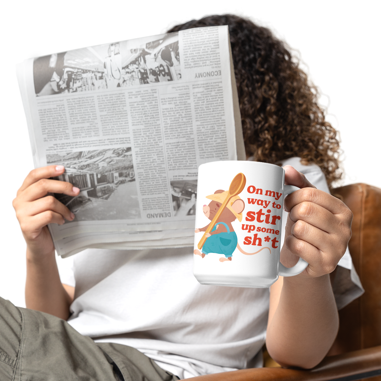 a woman reading a newspaper while holding a coffee mug