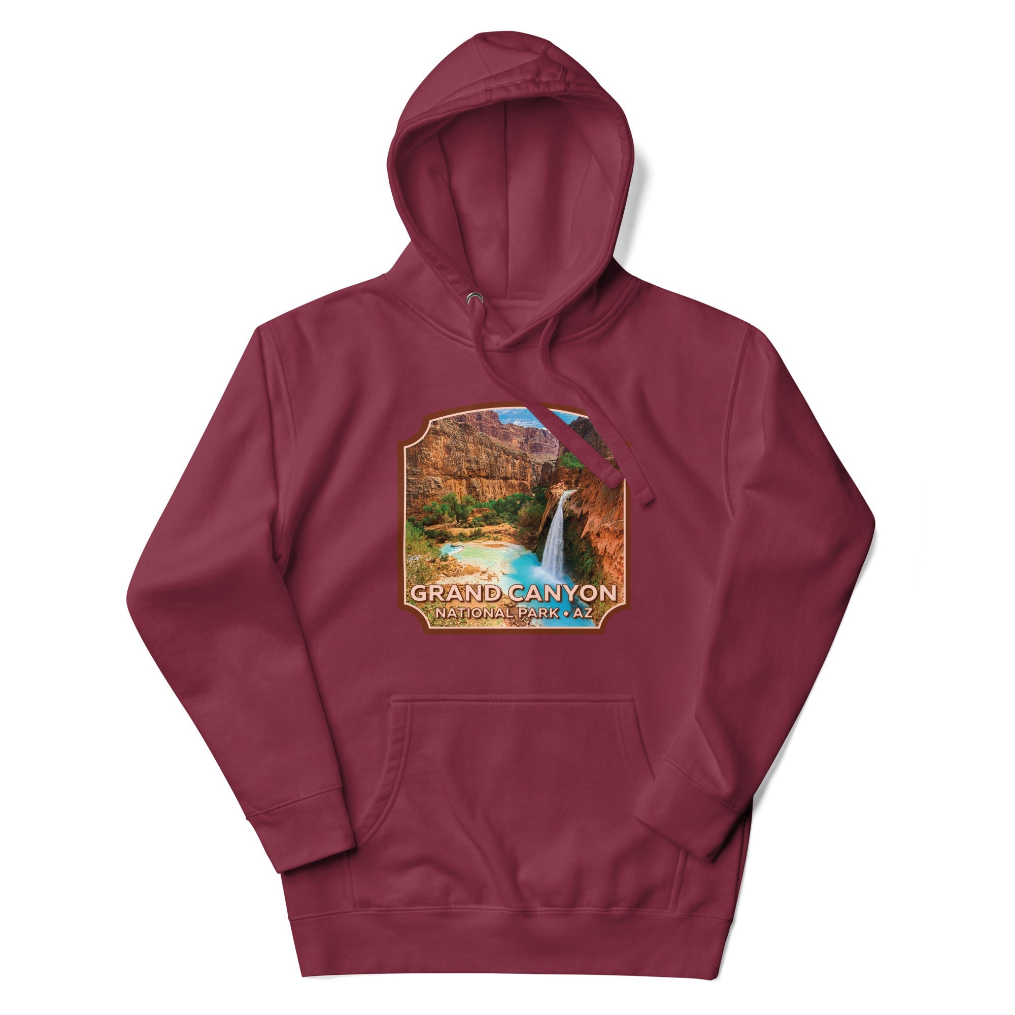 a maroon hoodie with a waterfall and mountains in the background